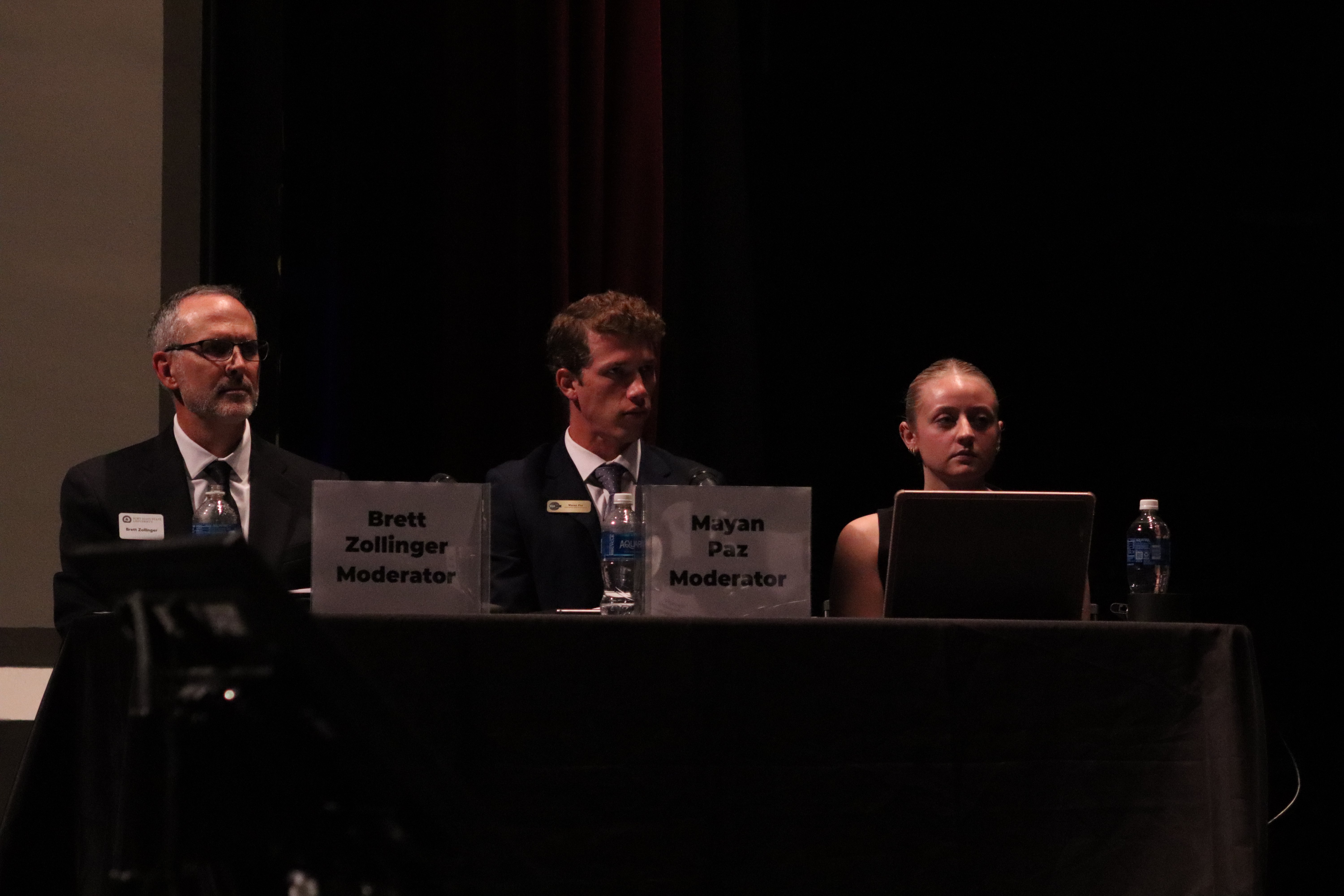 Moderators Brett Zollinger and Mayan Paz sit and listen to the candidates speak. Photo by Alin Hett/Hays Post.&nbsp;