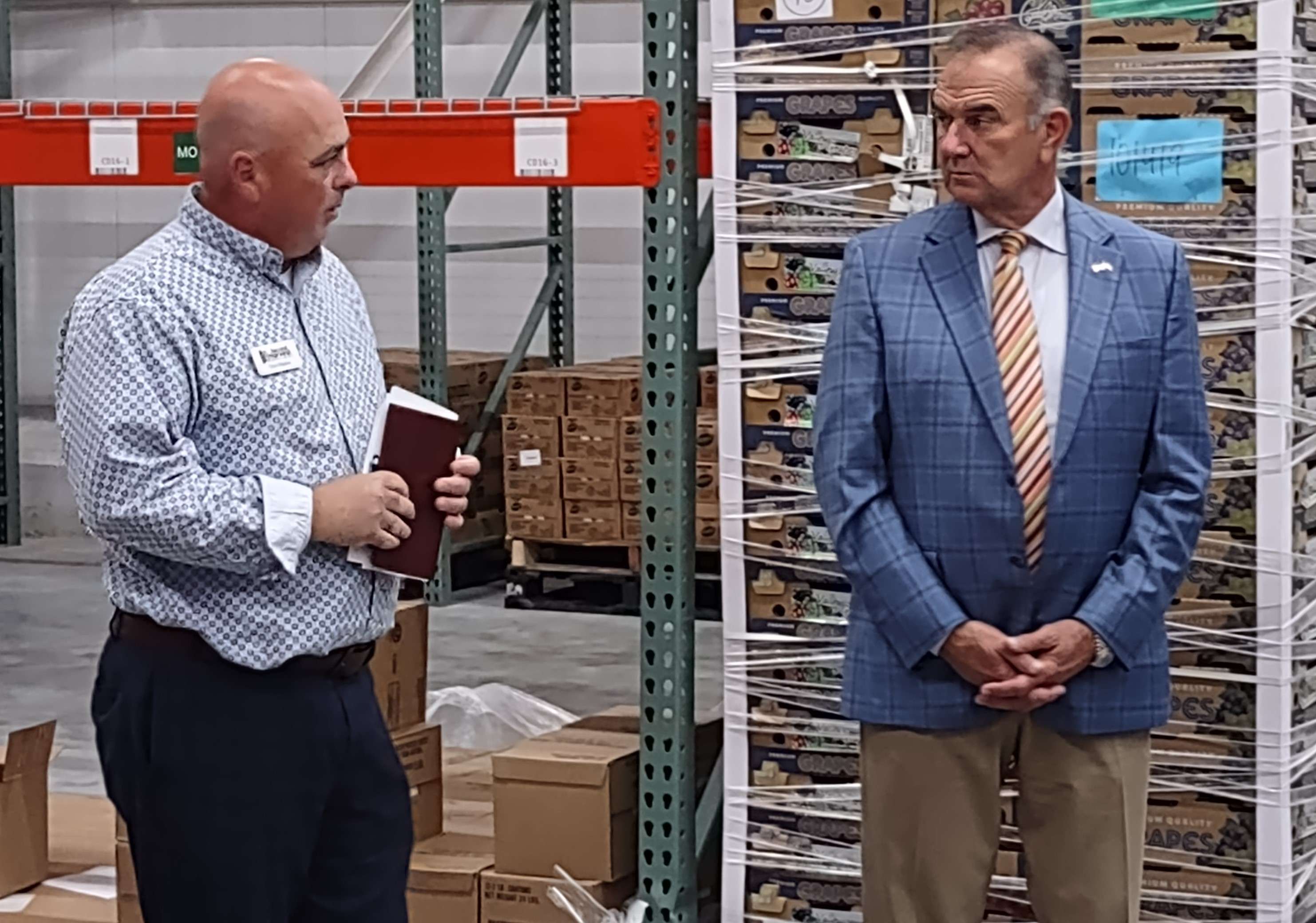 Kehoe (right), and Second Harvest CEO Chad Higdon in Second Harvest's new refrigeration unit.