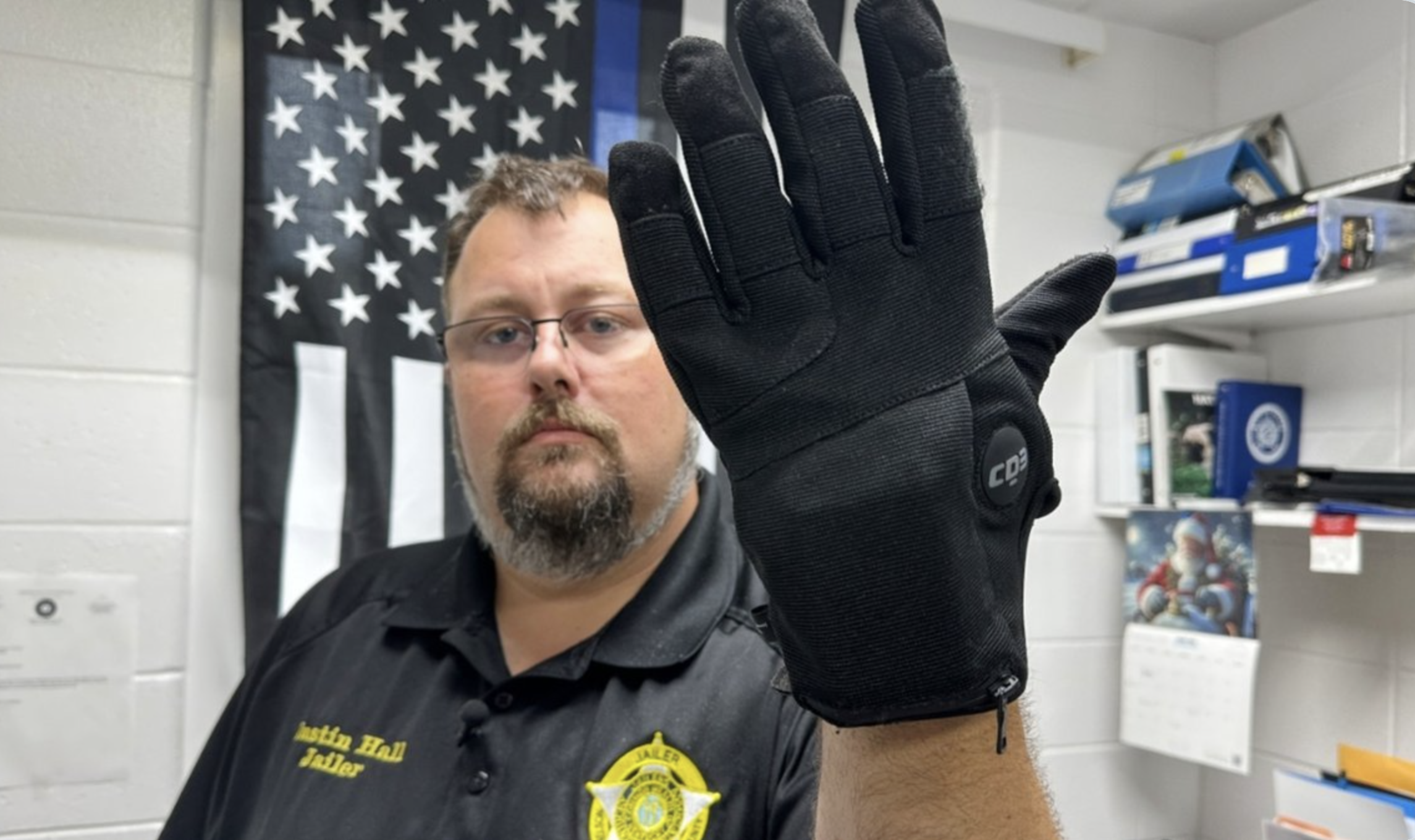 FILE - Nelson County, Ky., jailer Justin Hall shows an electric shock glove that is used at his facility, Aug. 13, 2026, in Bardstown, Ky. (AP Photo/Dylan Lovan, File)