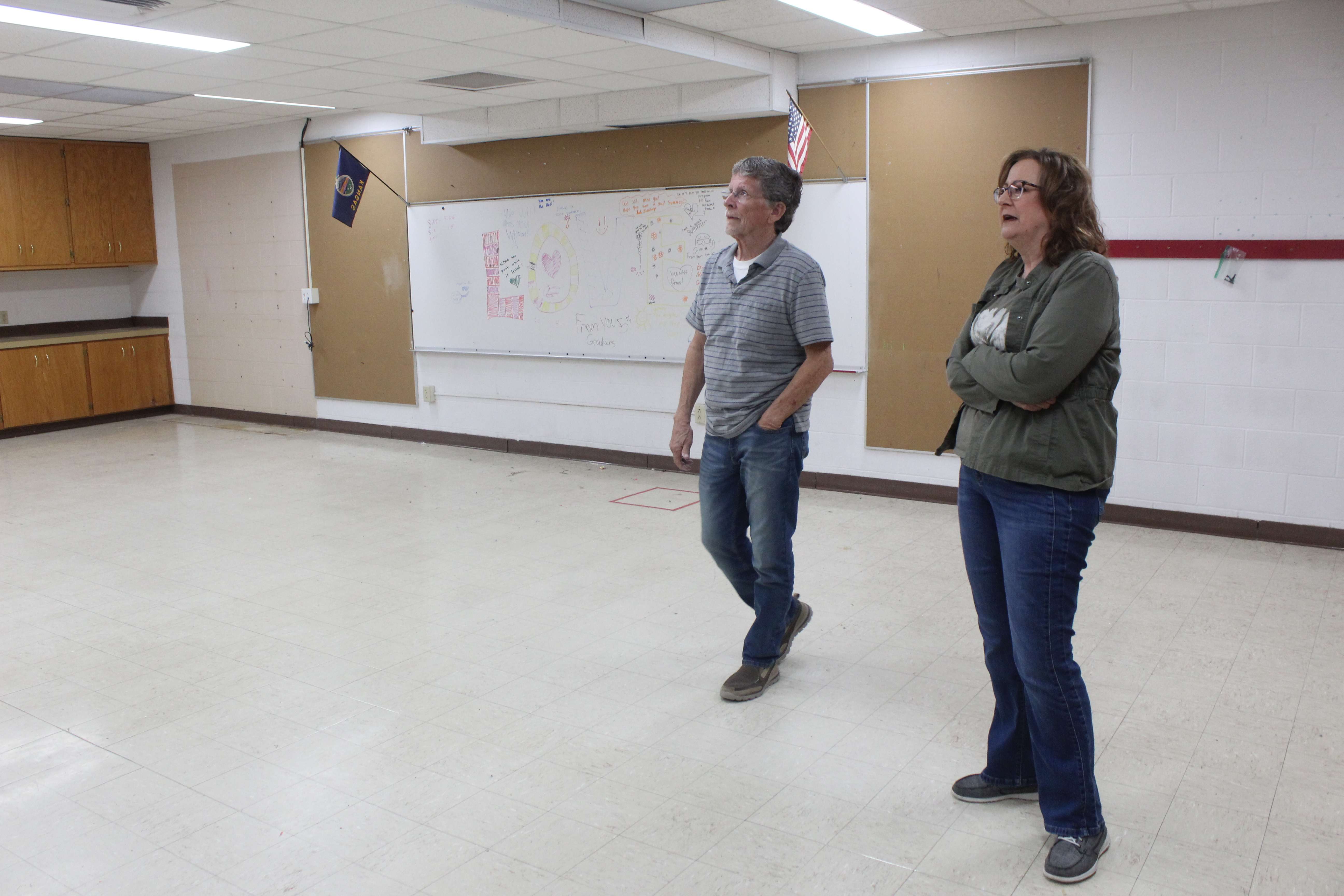 Hays school board members Craig Pallister, left, and Ruth Ruder, right, in former Wilson school's art room. The district is considering turning the space into a training room in the renovated administrative center. Photo by Cristina Janney/Hays Post