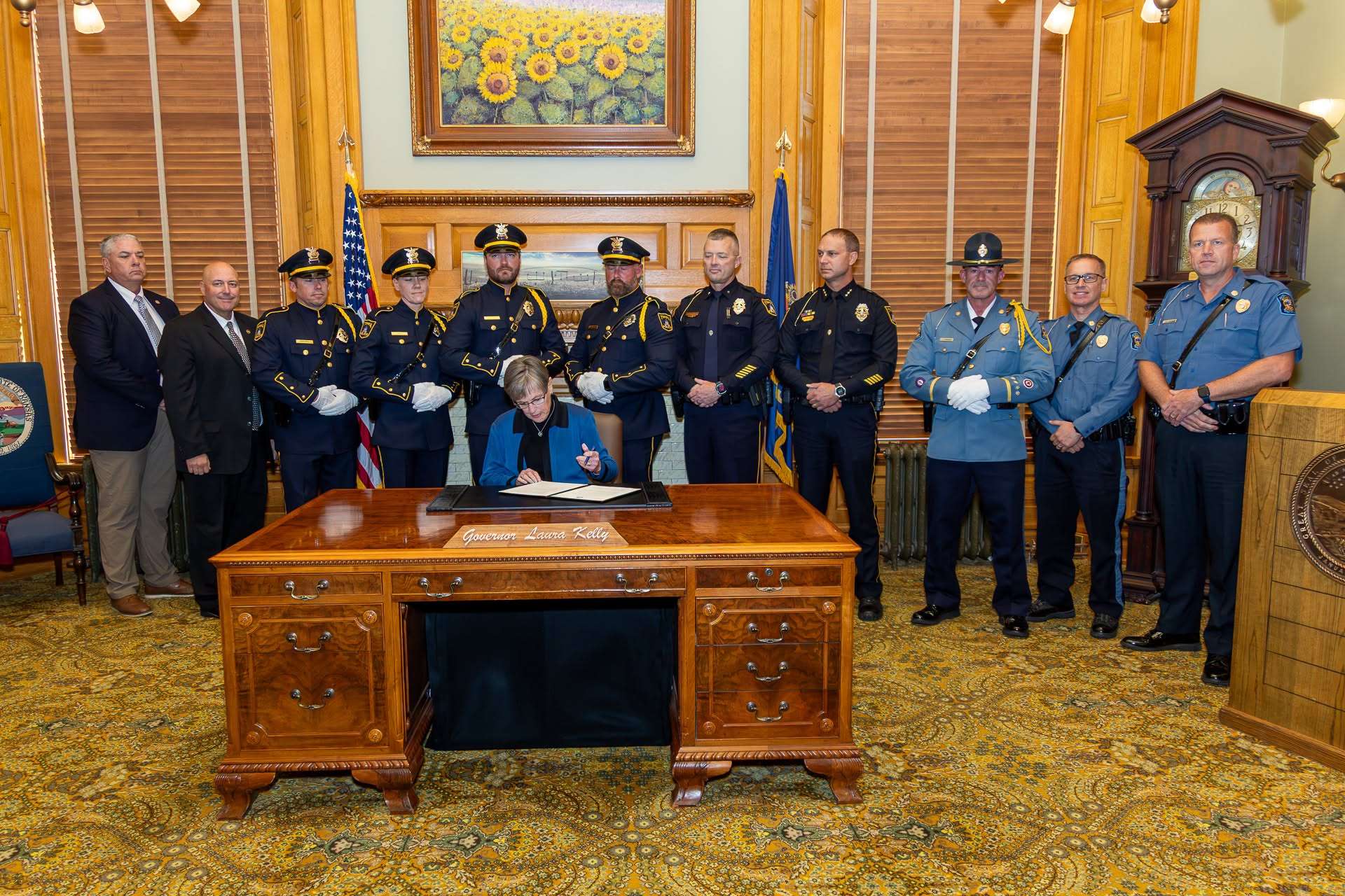 Governor Laura Kelly recently signs an executive order designating the first Friday of each May as Kansas Law Enforcement Officers’ Memorial Day (Photo courtesy Kansas Highway Patrol)