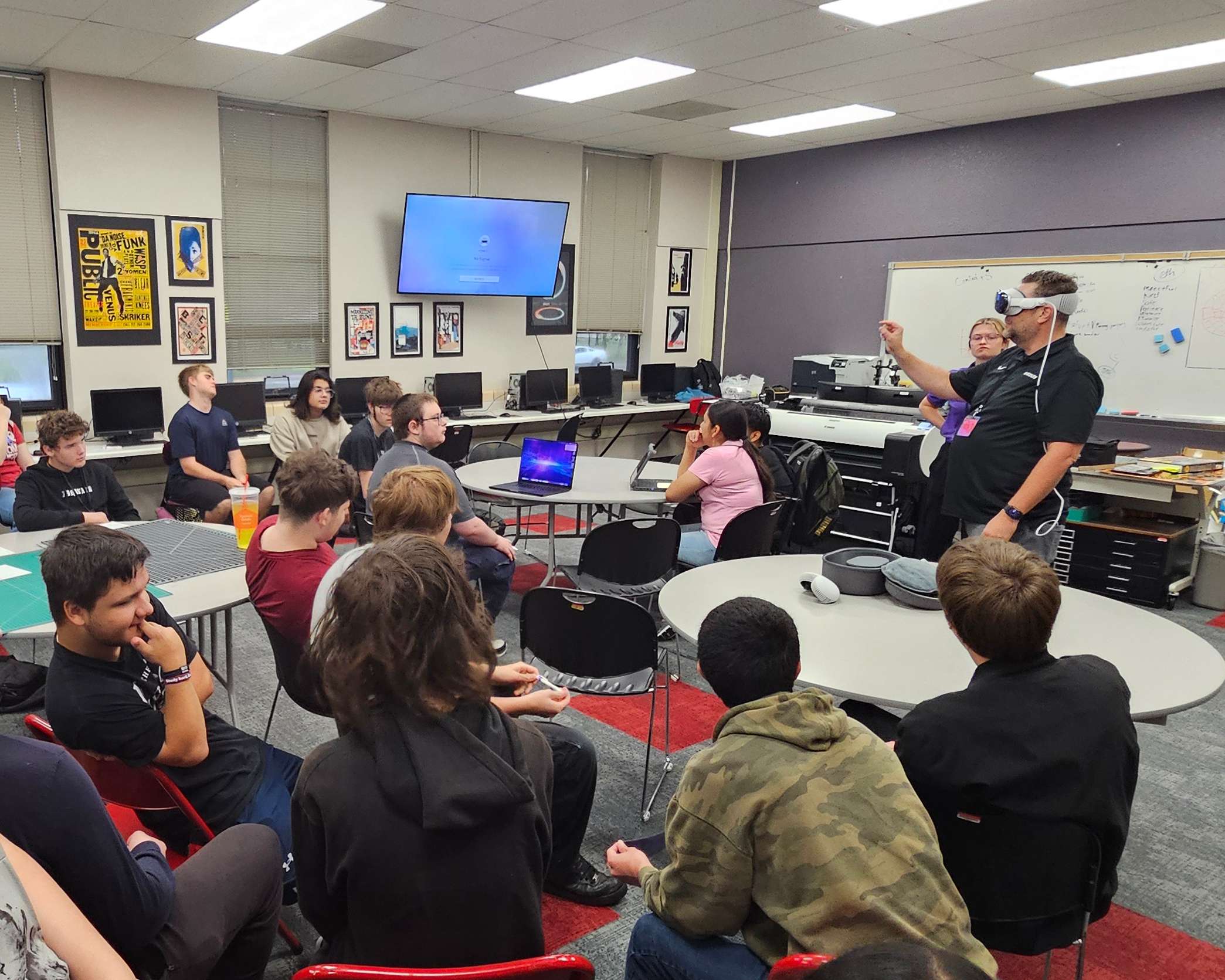 Great Bend High School students gather around a screen to mirror and view what their classmate was experiencing inside the virtual environment. (photo by Hugo Gonzalez/USD 428)