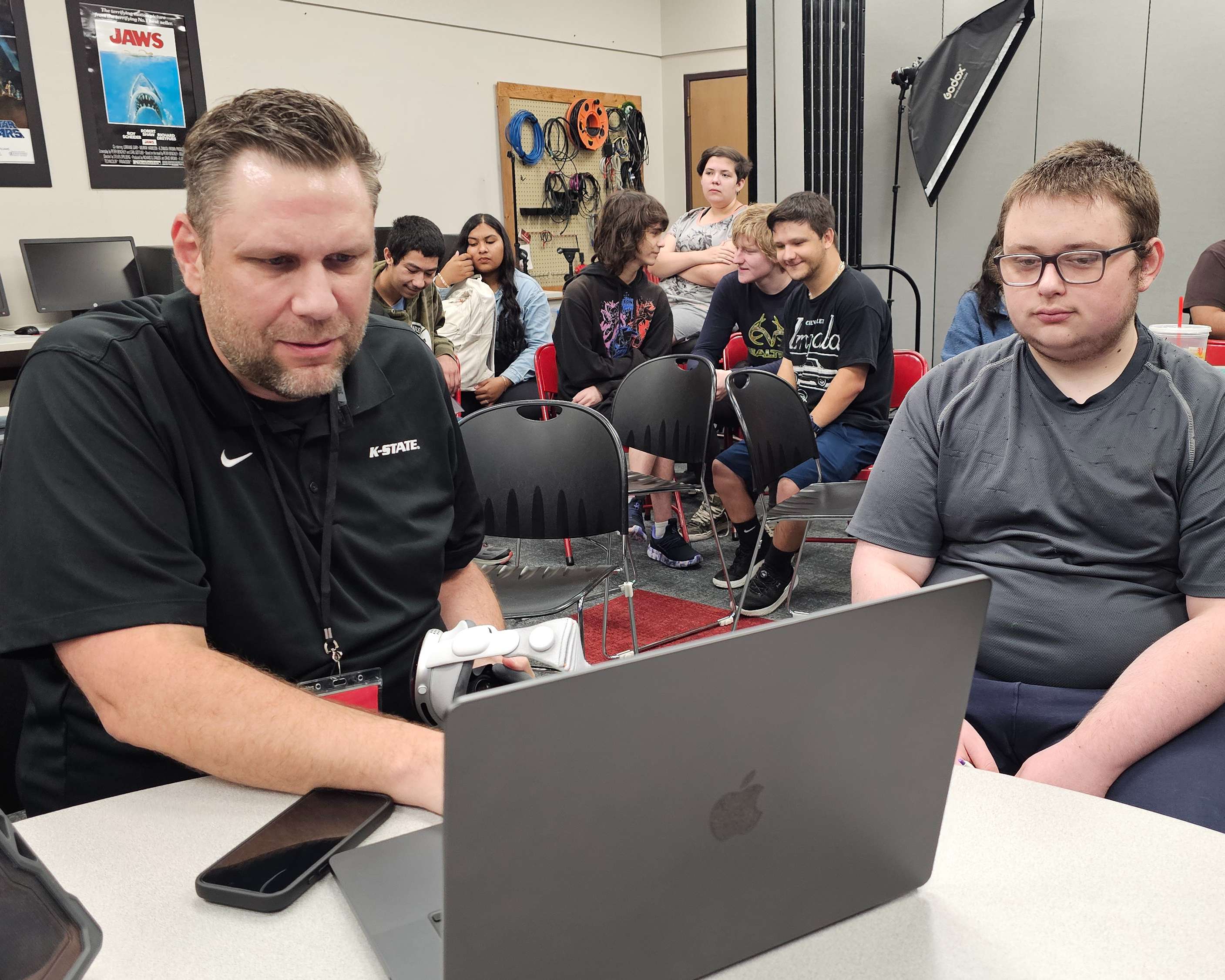 On Wednesday, Sept. 30, 2026, the K-State K-AIRES Director demonstrates how to navigate a JigSpace simulator using Apple Vision Pro headset technology. GBHS students then put on the headset to immerse themselves in an F1 race car simulation. (photo by Hugo Gonzalez)