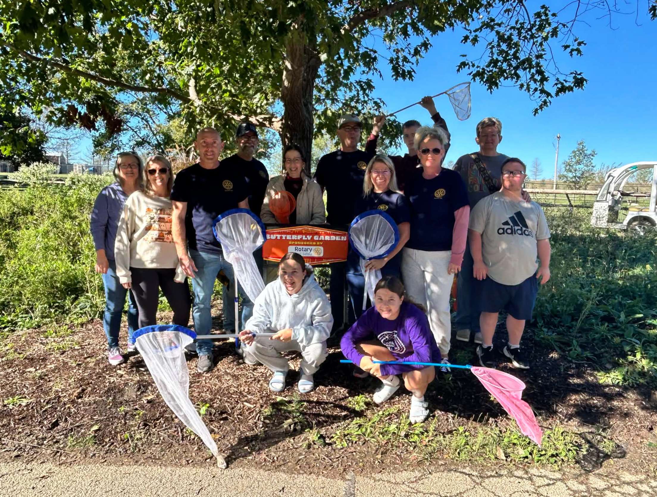 Members of the Rotary Club of Salina and their families participate in a monarch butterfly tagging event at Rolling Hills Zoo, collecting valuable migration data for the Monarch Watch conservation program while supporting pollinator habitat through two Rotary-sponsored butterfly gardens.