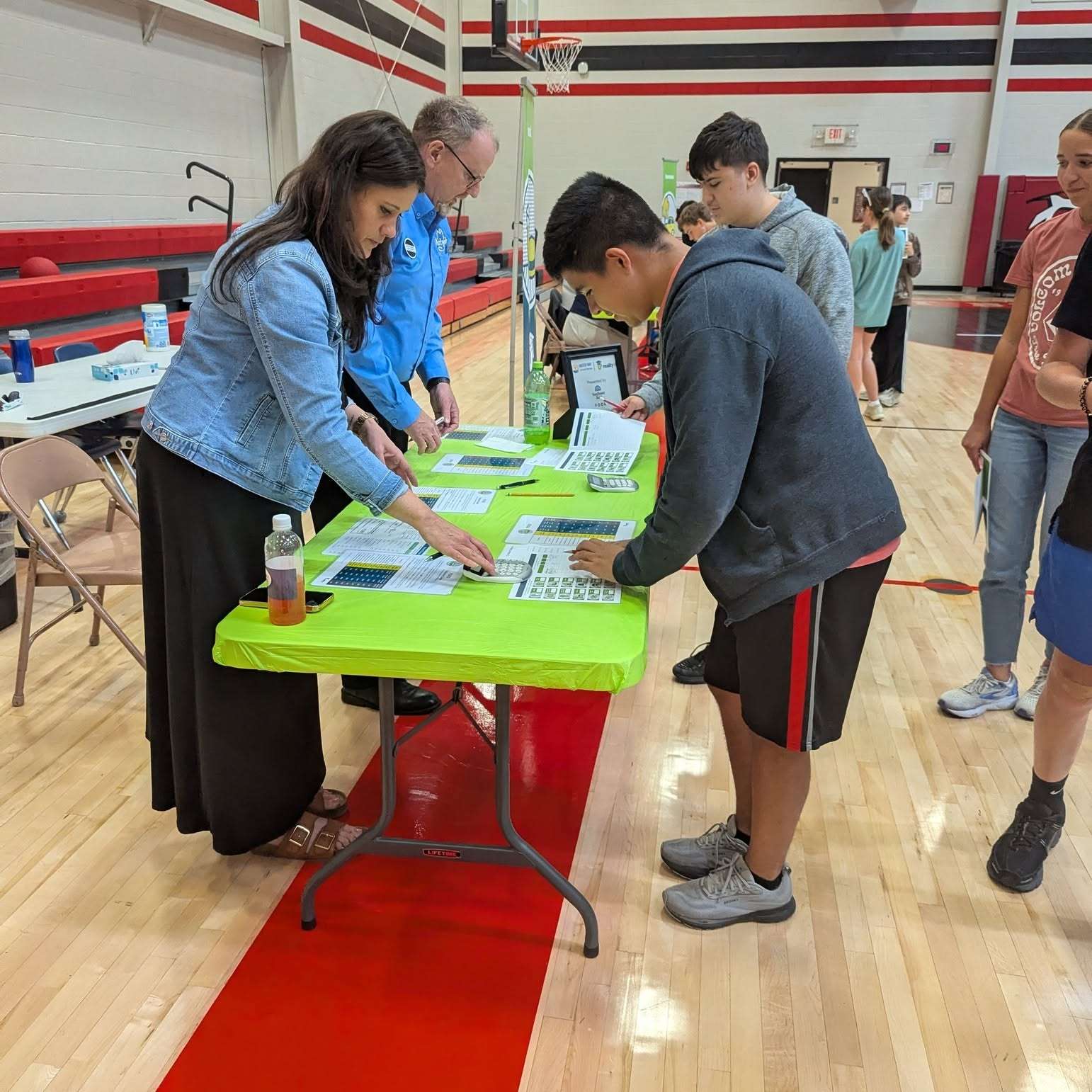 Students at the 2025 Reality U event explore “Reality University,” where they receive a fictional career and income, and then navigate a series of real-world financial decisions and living expenses such as car payments, utilities, insurance, and, of course, the unexpected realities of life.