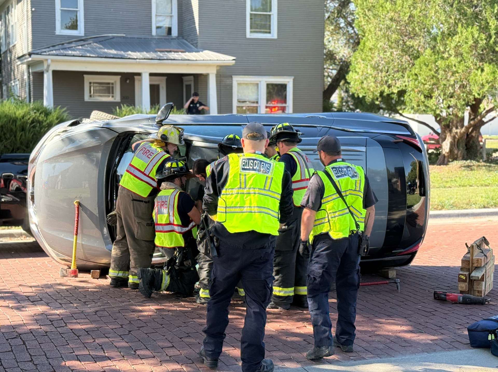 Hays firefighters work to extricate a driver from a rolled vehicle on 17th Street today. Photo by Cristina Janney/Hays Post