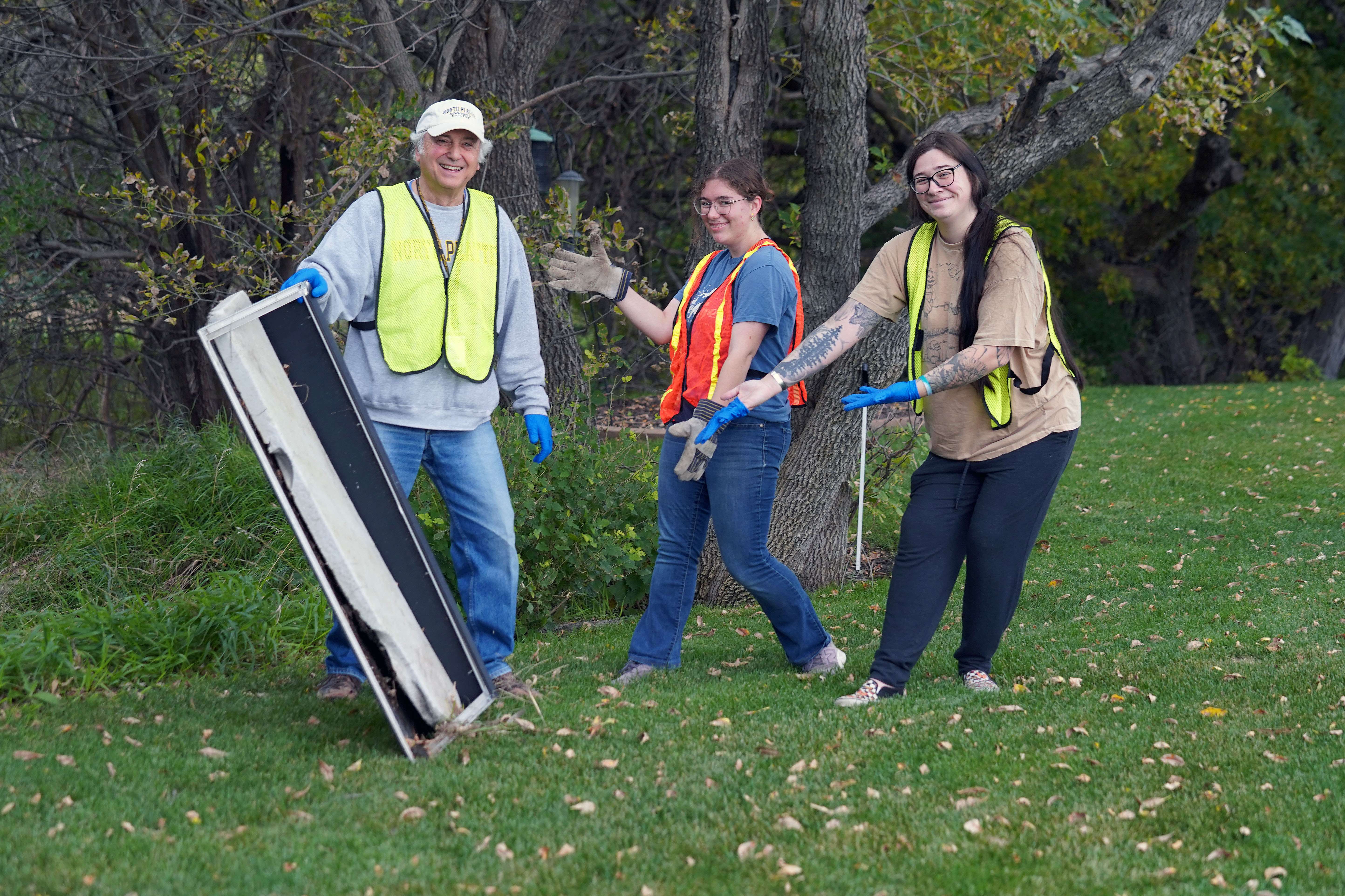 MPCC Instructor Dr. Glynn Wolar and PTK members Gianna Tejral and Alexandra Blackwell pick up litter during last year’s fall Trash-a-thon in North Platte. (Courtesy MPCC)