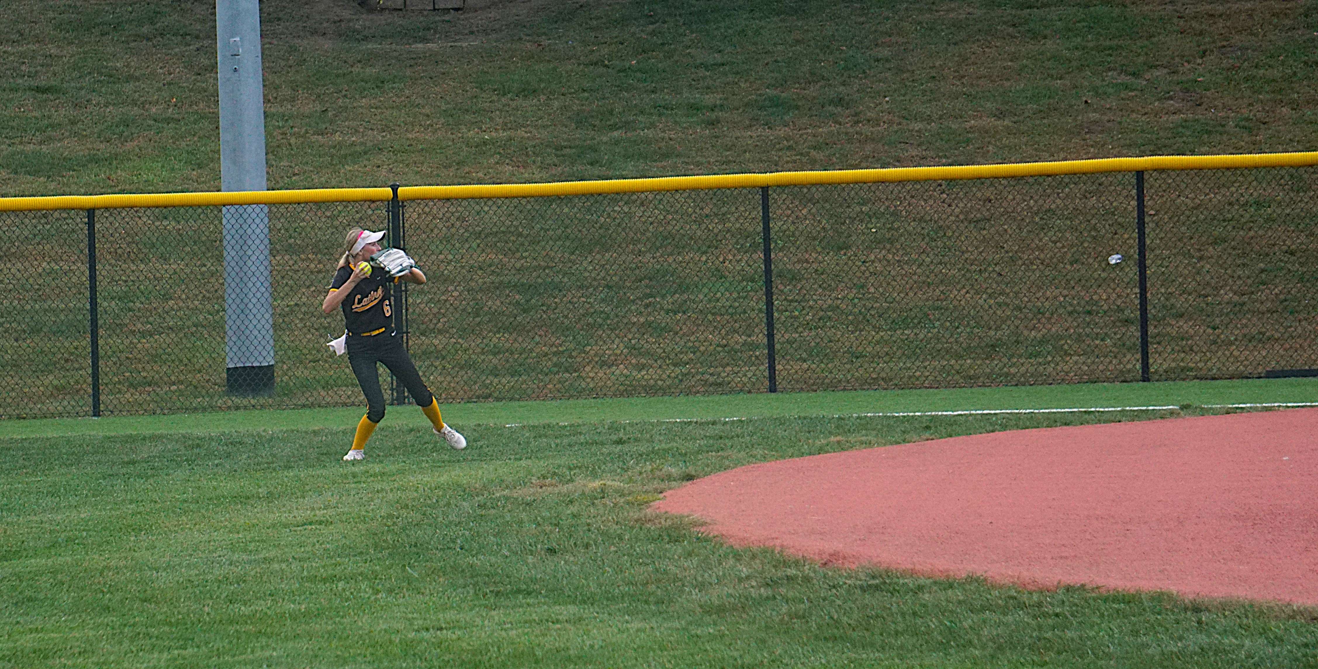 Lathrop right fielder Arlie Hawkins prepares to throw home after fielding a ball/ Photo by Matt Pike