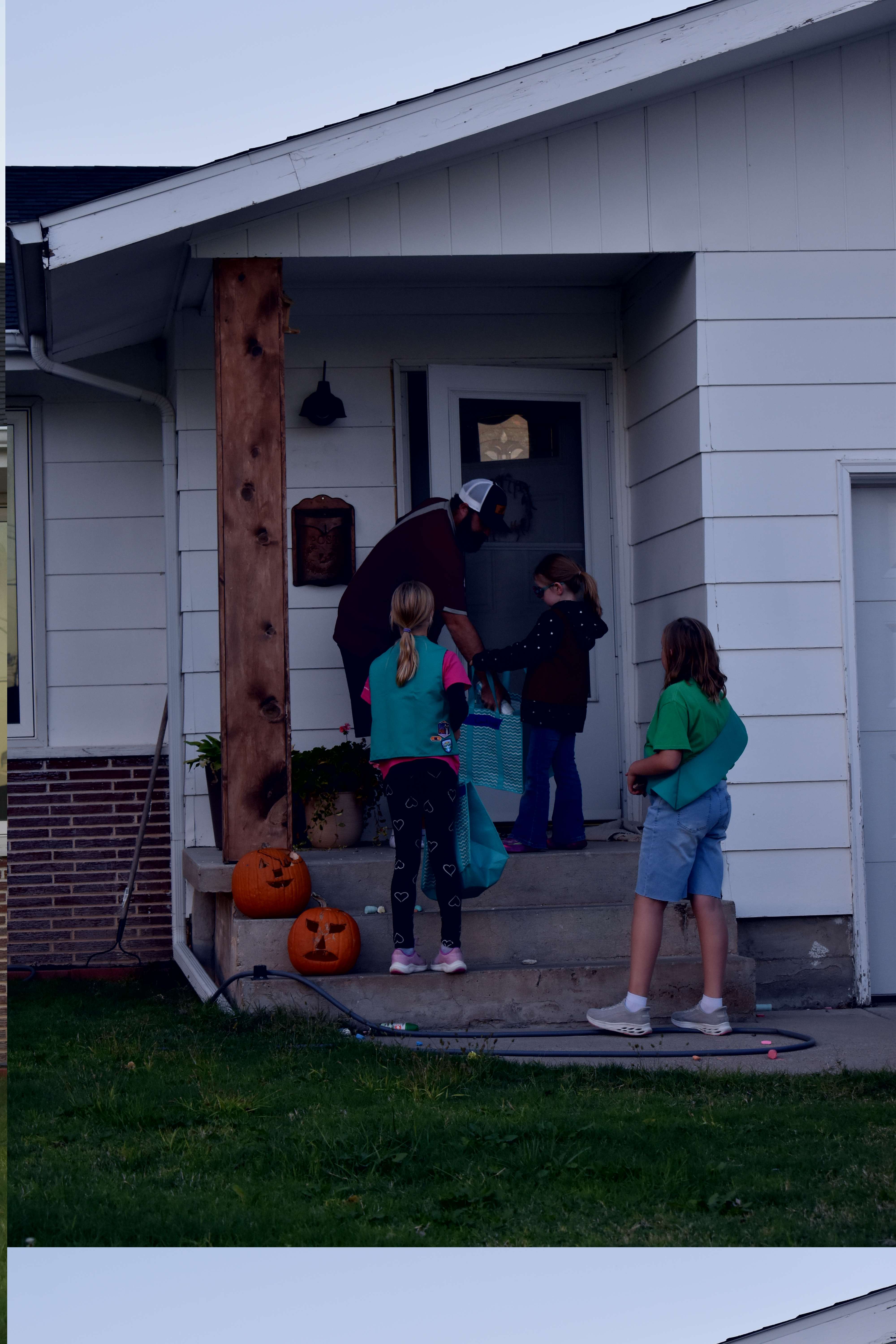 Local man donates to Girl Scout Troop 10088 as they went door to door in their designated area. The troop rang on doorbells and explained they were there collecting non-perishables for the food bank. Photo by Jami Morain/Hays Post