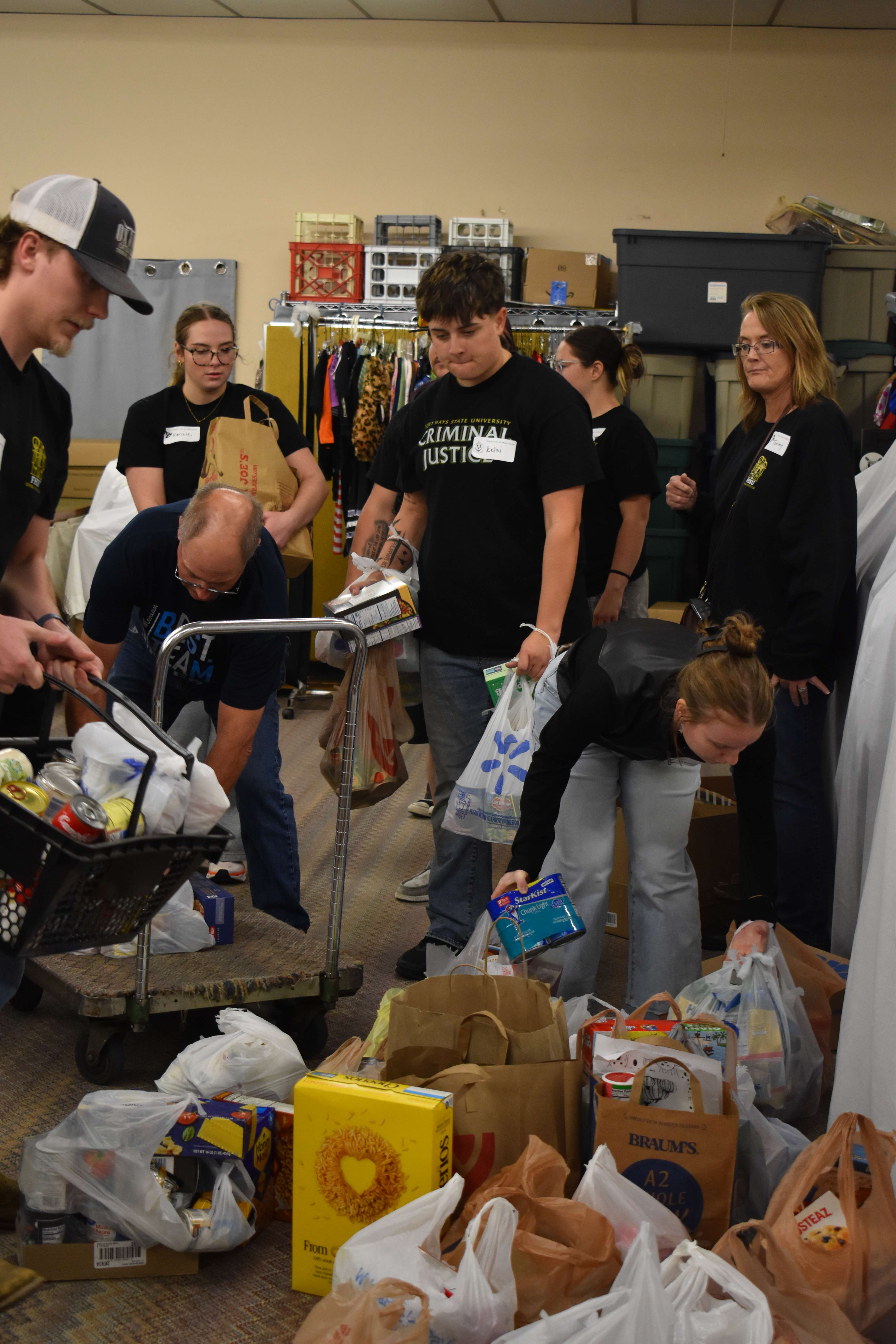 Fort Hays State University's Criminal Justice students dropping off collections from the community at the Food Assistance Center. Twenty seven organizations volunteered to help collect donations and were each given a designated area. Photo by Jami Morain/Hays Post&nbsp;