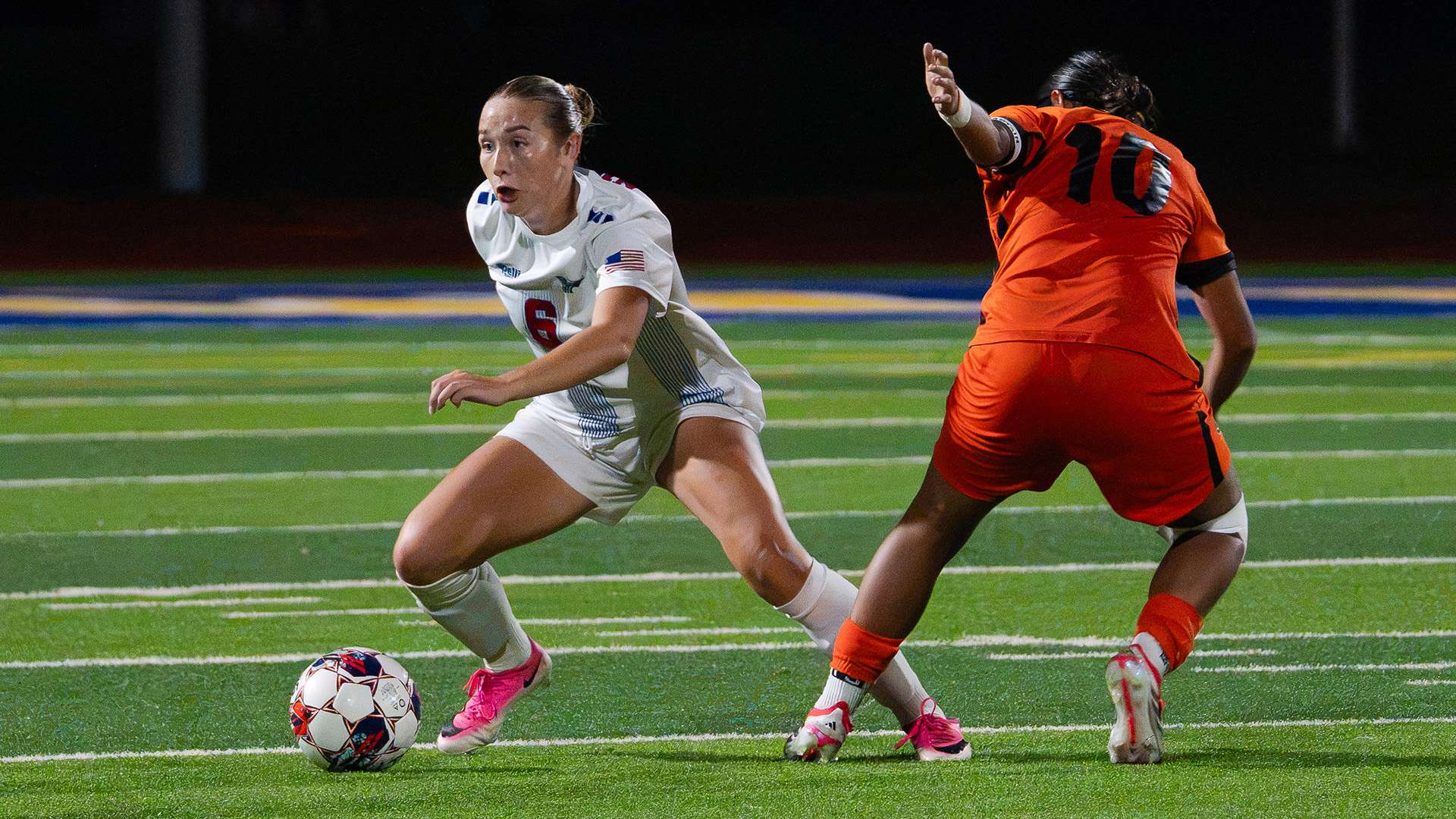 Blue Dragon midfielder Ella Swearingen works past a Cowley defender in Hutchinson's 2-1 loss on Wednesday at Don Michael Field. (Abby Filippi/Blue Dragon Sports Information)