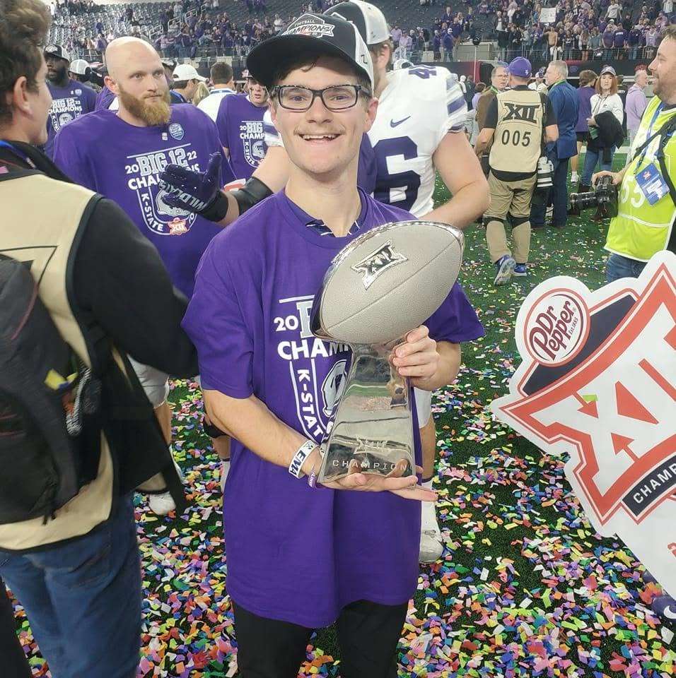 Garrett Reihs, a Haven native and former Kansas State football student equipment manager, poses with the Big 12 championship trophy following the Wildcats' 31-28 overtime victory over TCU on Dec. 3, 2022, at AT&amp;T Stadium in Arlington, Texas. Reihs now works as a seasonal equipment manager for the New England Patriots. (Courtesy photo)