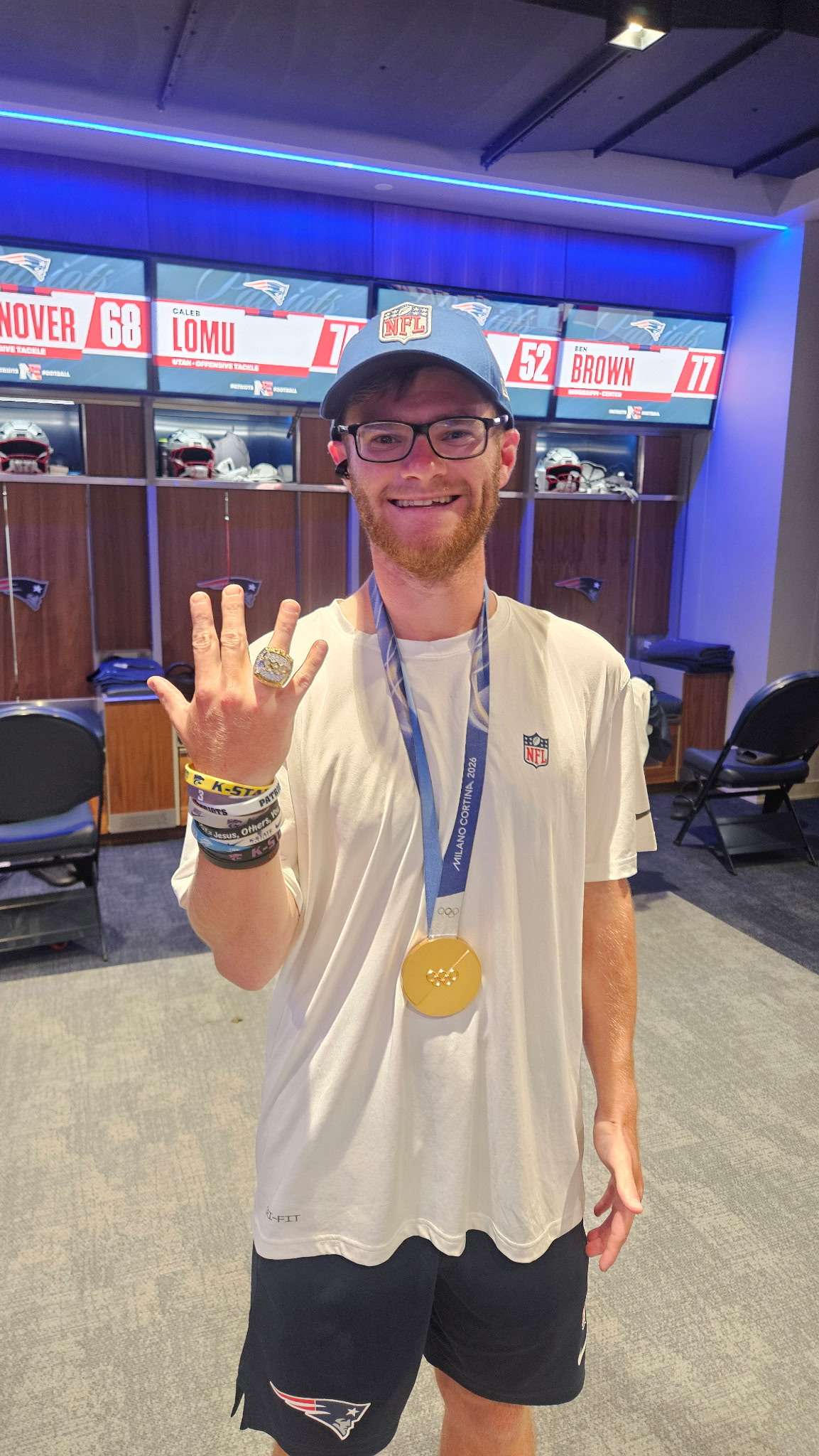 Haven native and New England Patriots equipment manager Garrett Reihs poses with an Olympic gold medal and championship ring belonging to U.S. women's hockey star Hilary Knight during her visit to Gillette Stadium in Foxborough, Massachusetts, earlier this season. Reihs joined the Patriots for the 2026 season after previously serving as a training camp intern in 2025. (Courtesy photo)