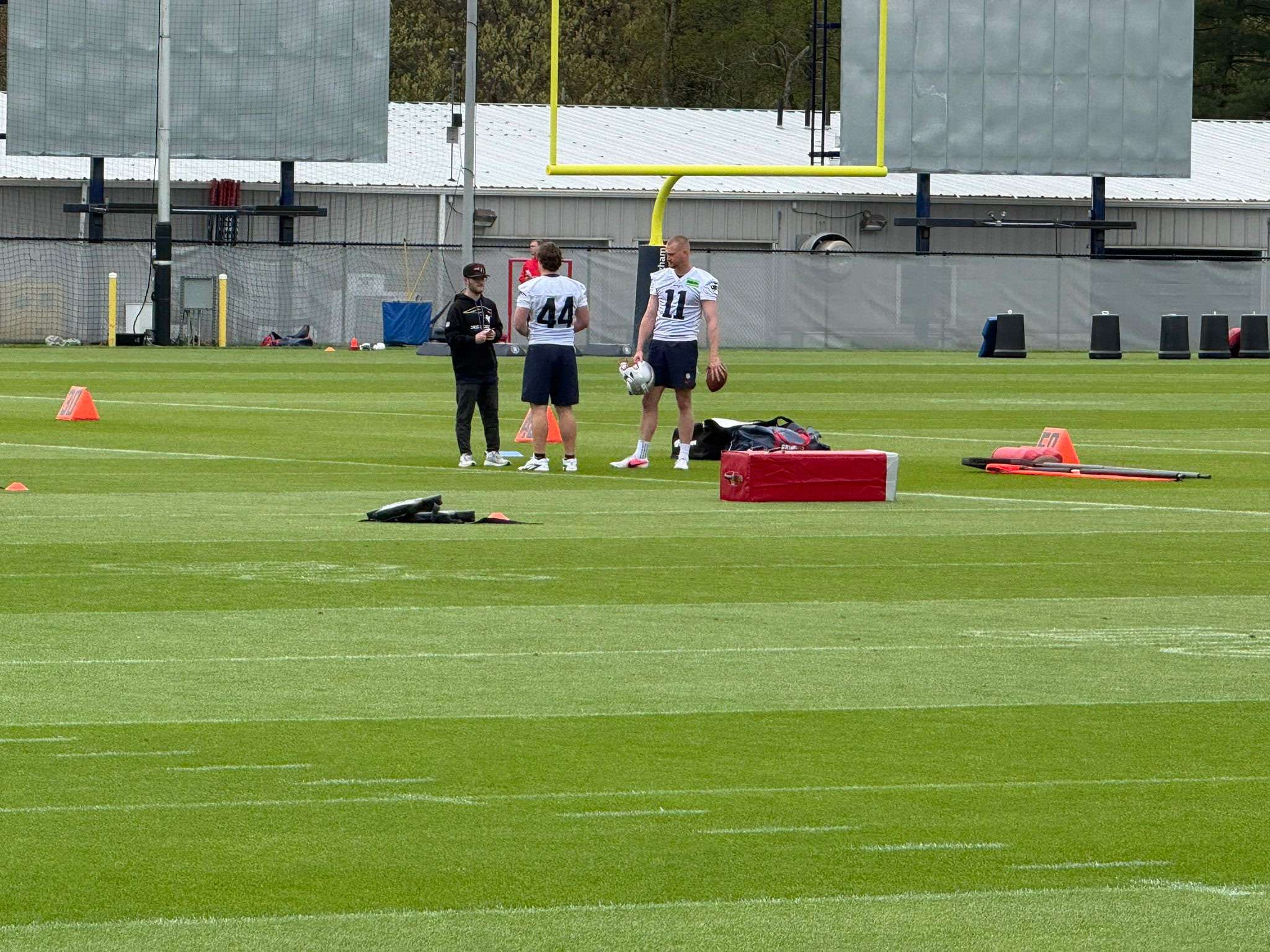 Garrett Reihs, left, assists with special teams preparations during a New England Patriots practice at the New Balance Athletics Center in Foxborough, Massachusetts. The Haven native works primarily with the Patriots' specialists, including kickers, punters and long snappers, as part of the team's equipment staff. (Courtesy photo)