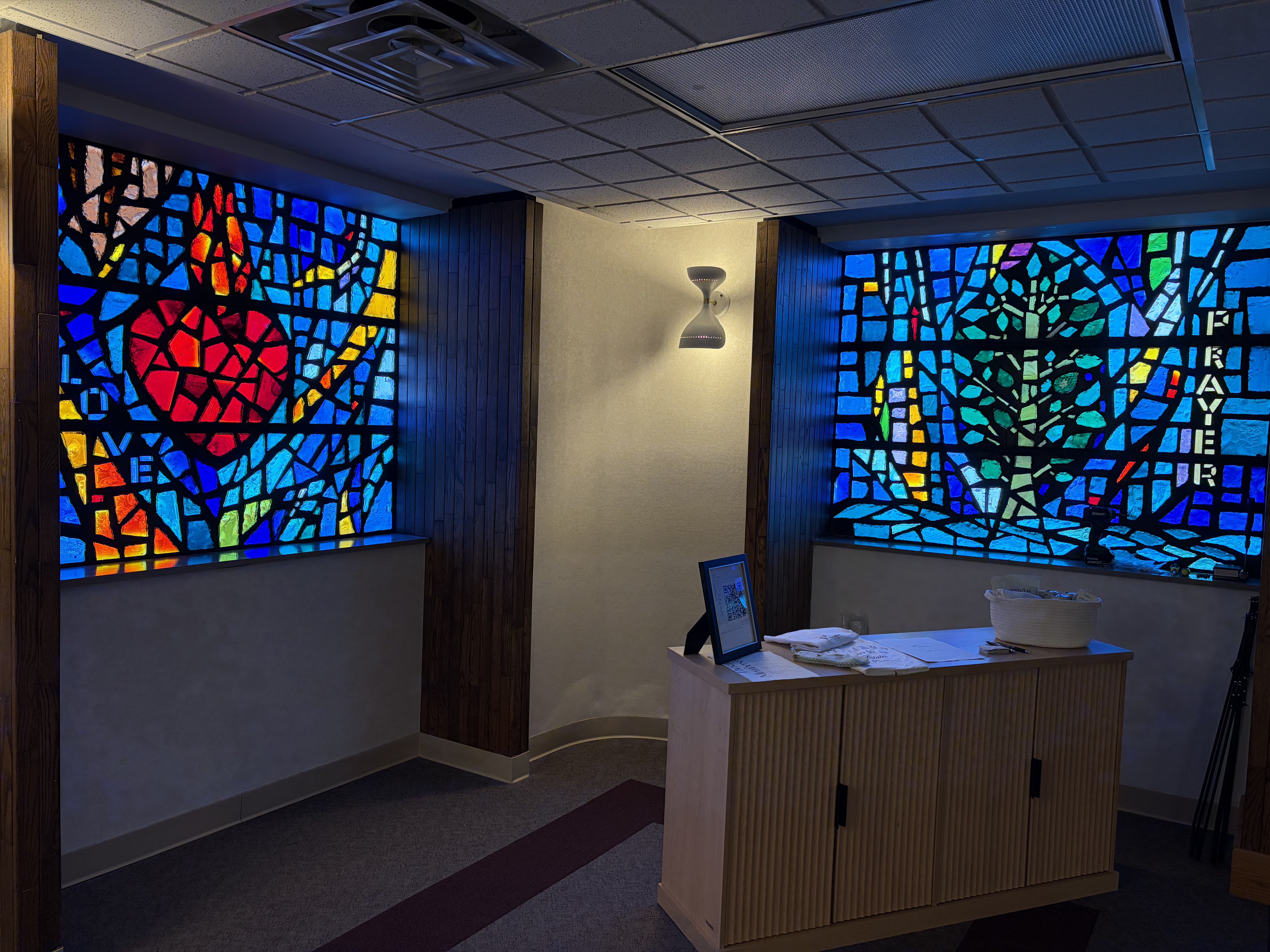 Two of the four stain-glass windows detailing the words "Love" and "Prayer" located inside Pilates &amp; Strength Studio by Isabelle. Photo by Alin Hett/Hays Post