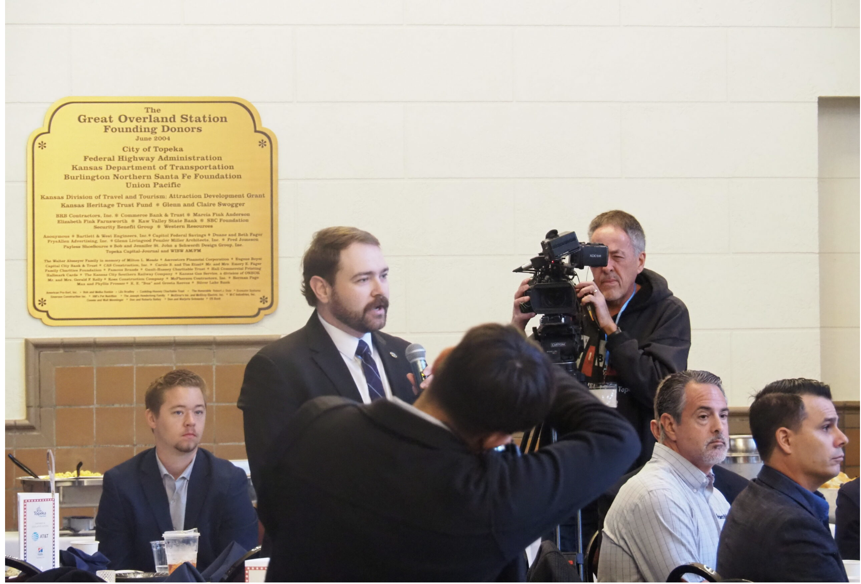 Zac Surritt, part of the third generation of family leadership at R&S Maintenance in Meriden, questions U.S. Sen. Roger Marshall about tariffs during an Oct. 16, 2026, candidate forum at Great Overland Station in Topeka. (Photo by Tim Carpenter/Kansas Reflector)