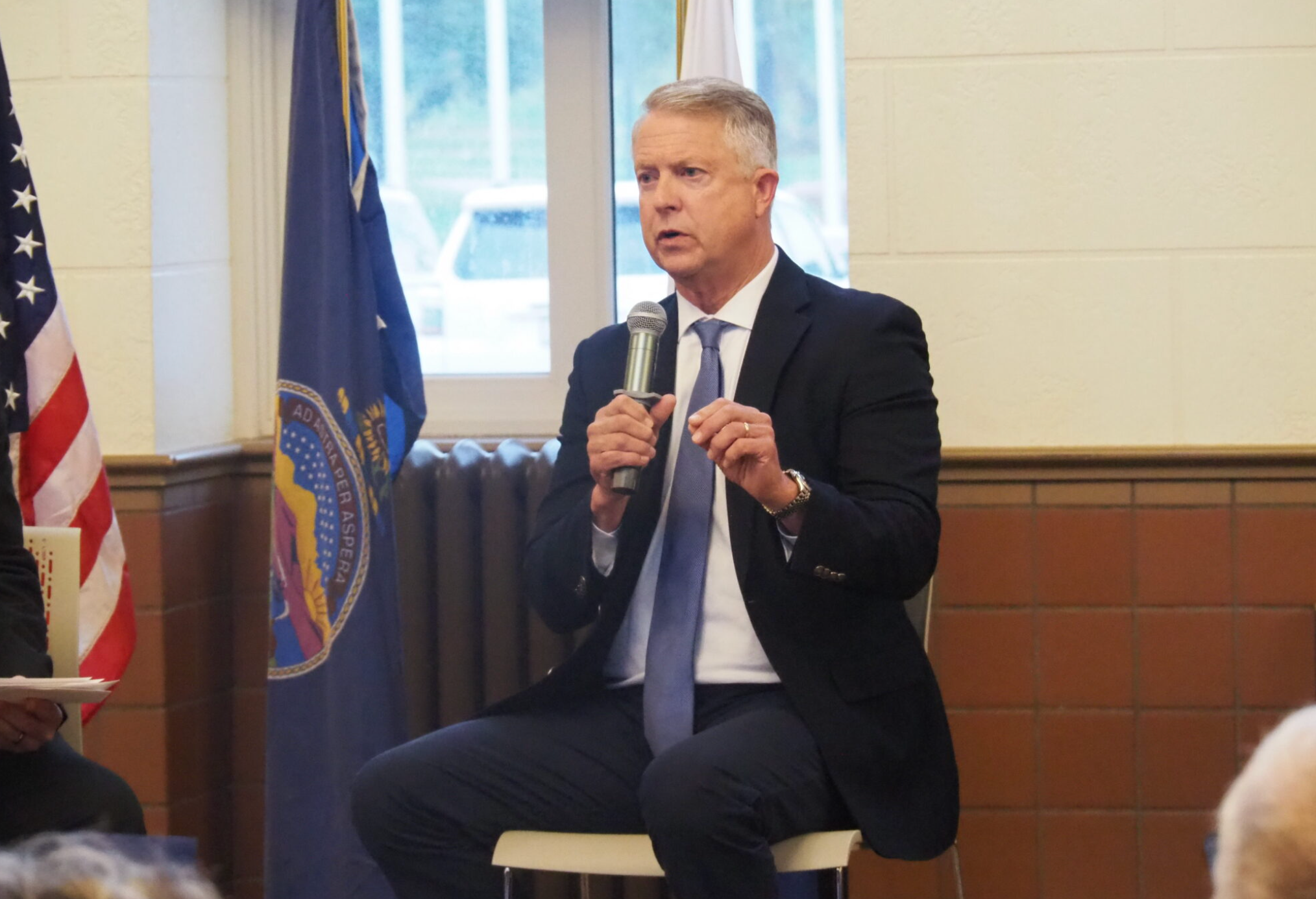 U.S. Sen. Roger Marshall, R-Kansas, discounts the experience of a Meriden businessman’s concern that global demand for U.S. products was diminished by President Donald Trump’s tariffs during a candidate forum Oct. 16, 2026, at Great Overland Station in Topeka. Marshall is in a tight reelection campaign with Democrat Adam Hamilton. (Photo by Tim Carpenter/Kansas Reflector)
