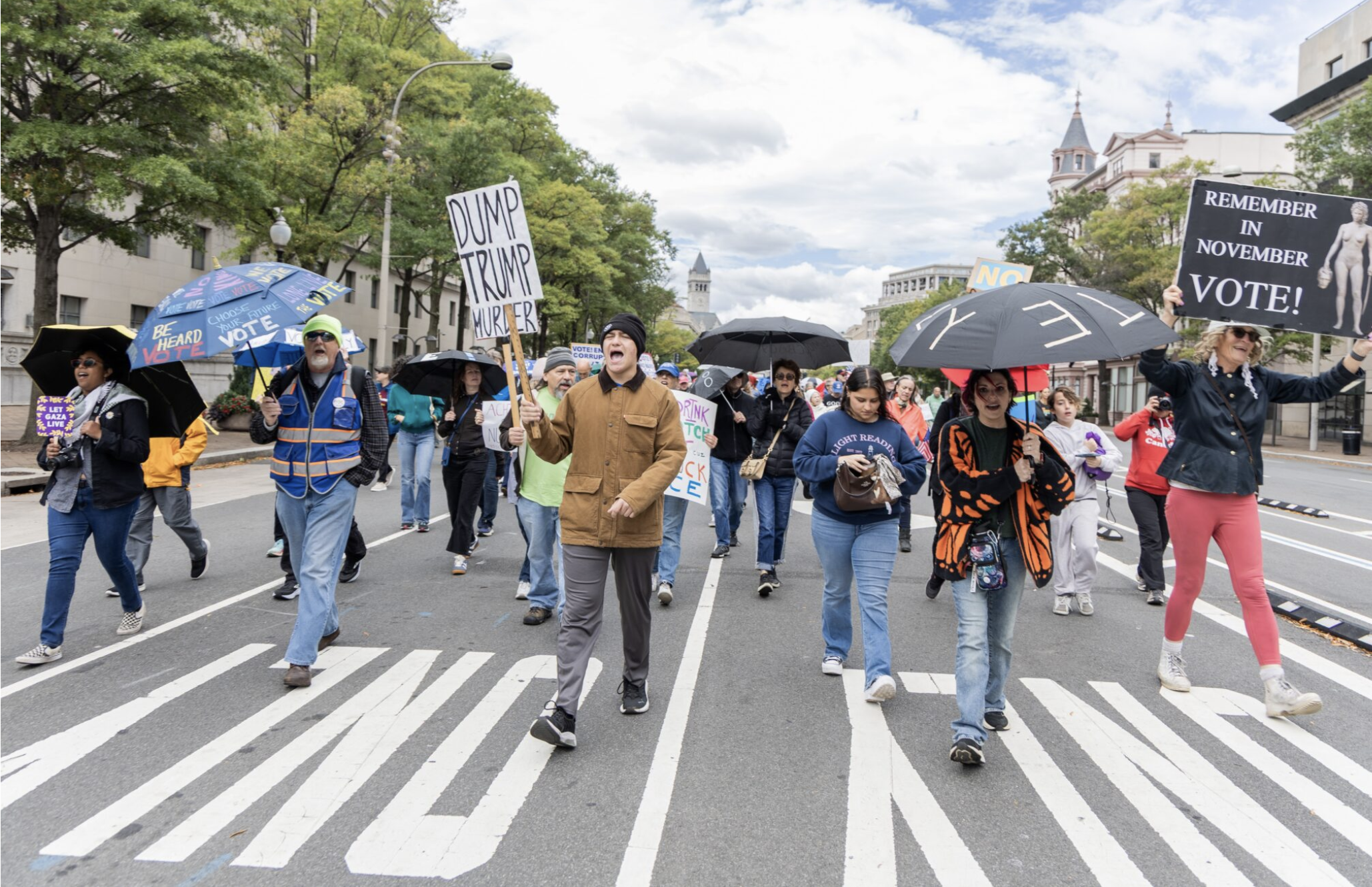  Participants in a No Kings day event march toward the U.S. Capitol in Washington, D.C., on Oct. 17, 2026. The Umbrella Walk 4 Change was one of thousands of No Kings events across the nation encouraging early voting. (Photo by Baya Burgess/States Newsroom)