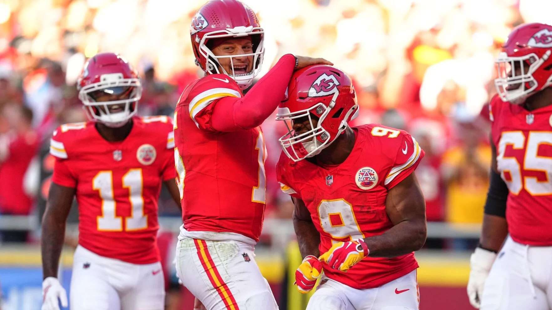 Kansas City Chiefs quarterback Patrick Mahomes, center left, and Kenneth Walker III (9) celebrate a touchdown scored on a rushing play by Walker III during the first half of an NFL football game against the Los Angeles Chargers in Kansas City, Mo., Sunday, Oct. 18, 2026. (AP Photo/Ed Zurga)