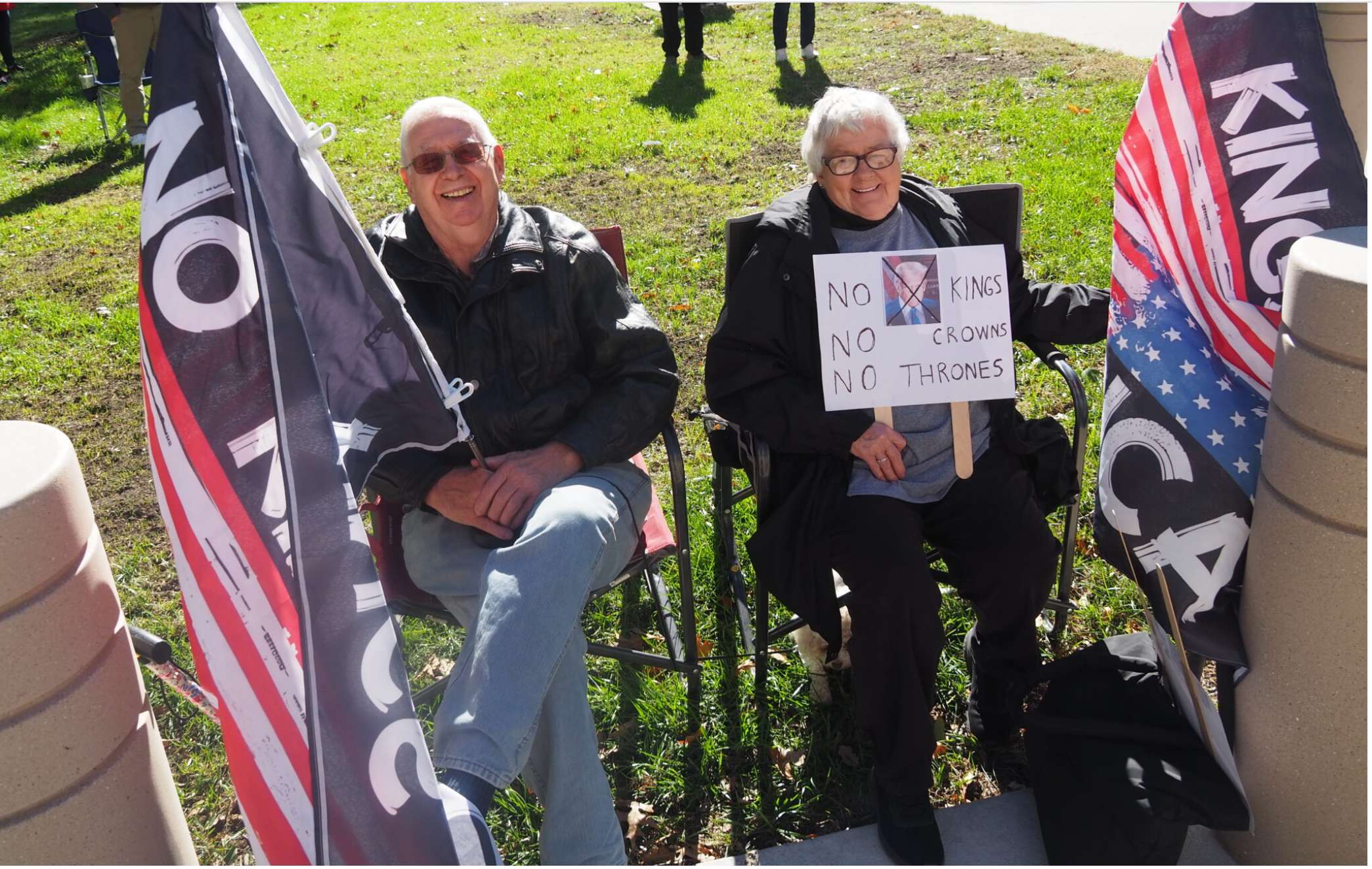  Howard Tyler and Mary Oswald, siblings from Horton, put flags in the ground Oct. 17, 2026, outside the Kansas Capitol to register their concern about the U.S. government and to emphasize the importance of voting by Nov. 3. (Photo by Tim Carpenter/Kansas Reflector)