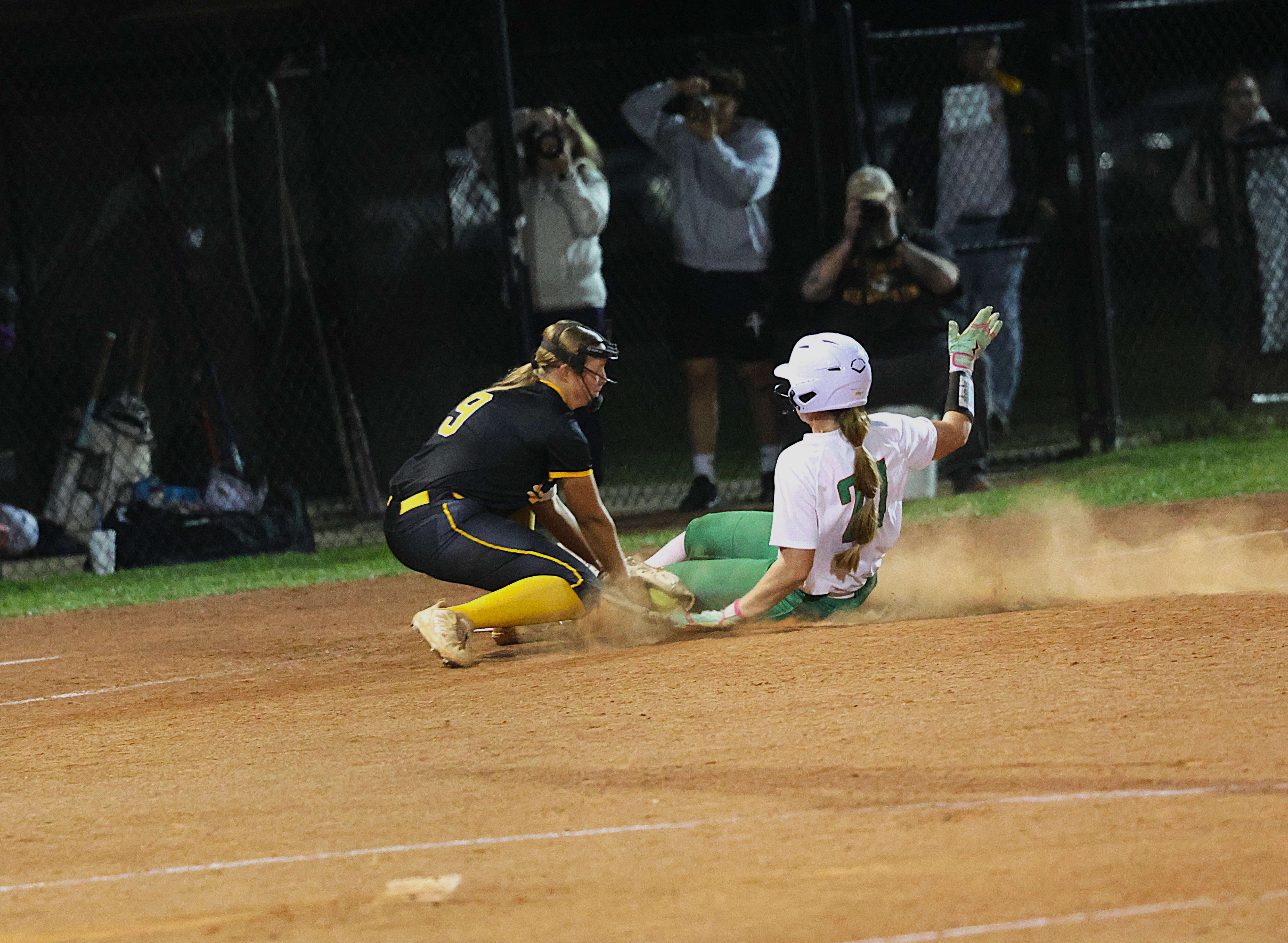 Mid-Buchanan's Booklee Thomas (21) slides behind the tag of Lathop third baseman Maddie Neill/ Photo by Matt Pike