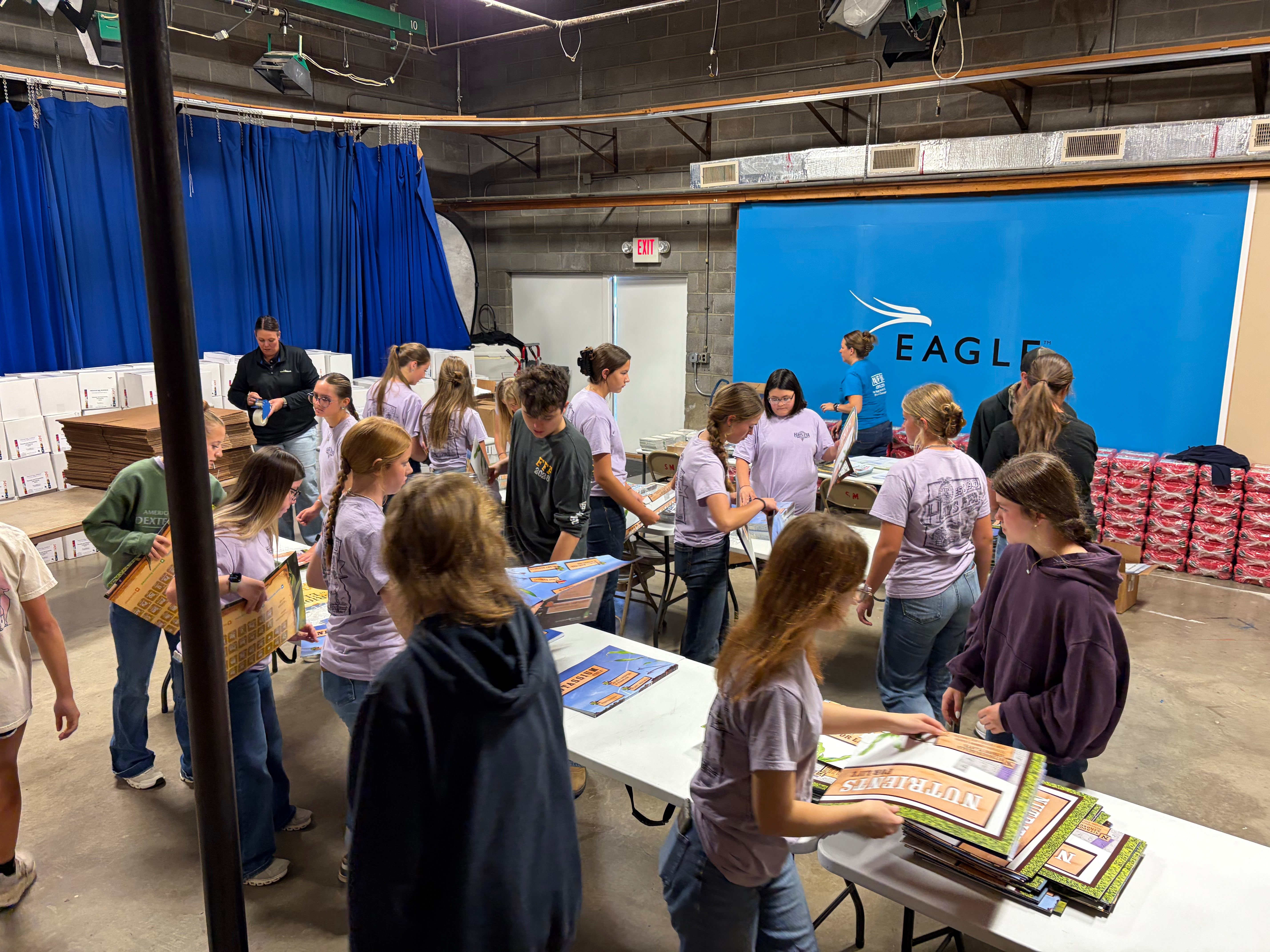 Hays High School FFA students helped pack Nutrients for Life Fertilizer Fun Boxes, which include soil samples, testing kits and classroom lessons. Photo by Alin Hett/Hays Post<br>