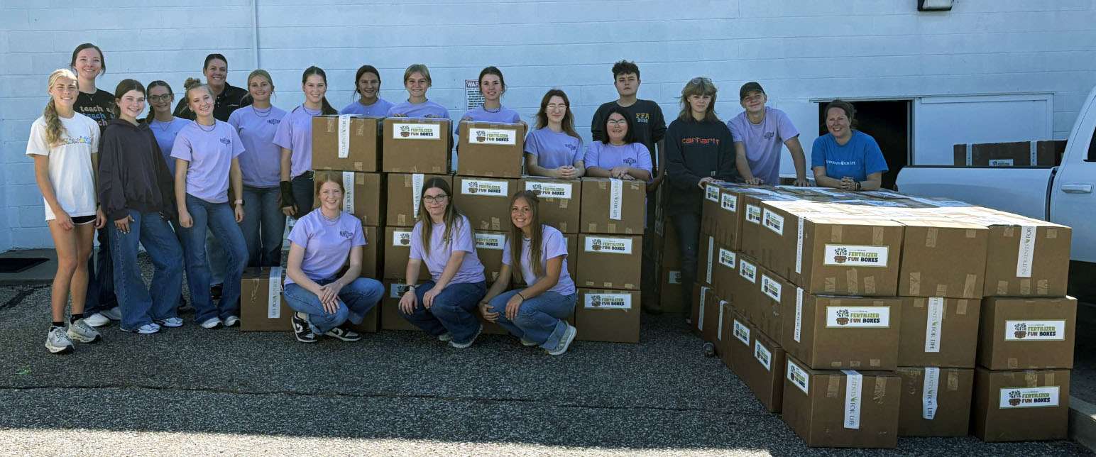 Hays High School FFA students pose for a picture with the completed Nutrients for Life Fertilizer Fun Boxes. Photo by Alin Hett/Hays Post