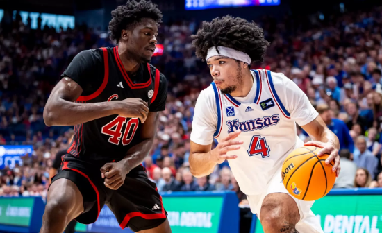 Kansas freshman guard Ty Stokes (4) drives past Louisville's Flory Bidunga (40) during an exhibition NCAA basketball game on Wednesday, October 21, 2026 in Lawrence, Kan. (Kansas Athletics photo)