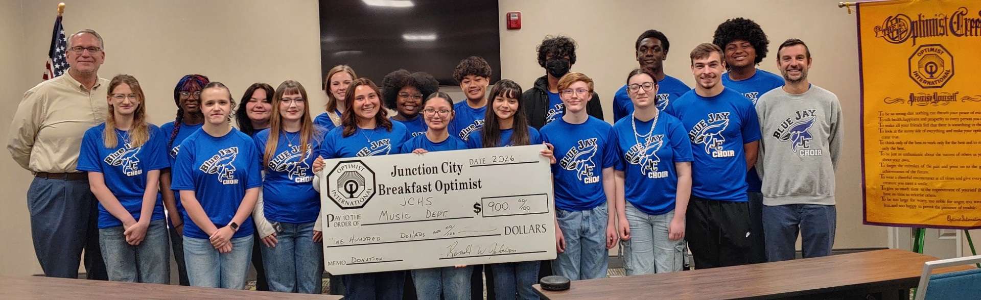 Pictured at the left is Ron Johnson, JC Breakfast Optimist Club President; JC Singers and at the far right Michael Brown, JCHS Vocal Music Instructor. 