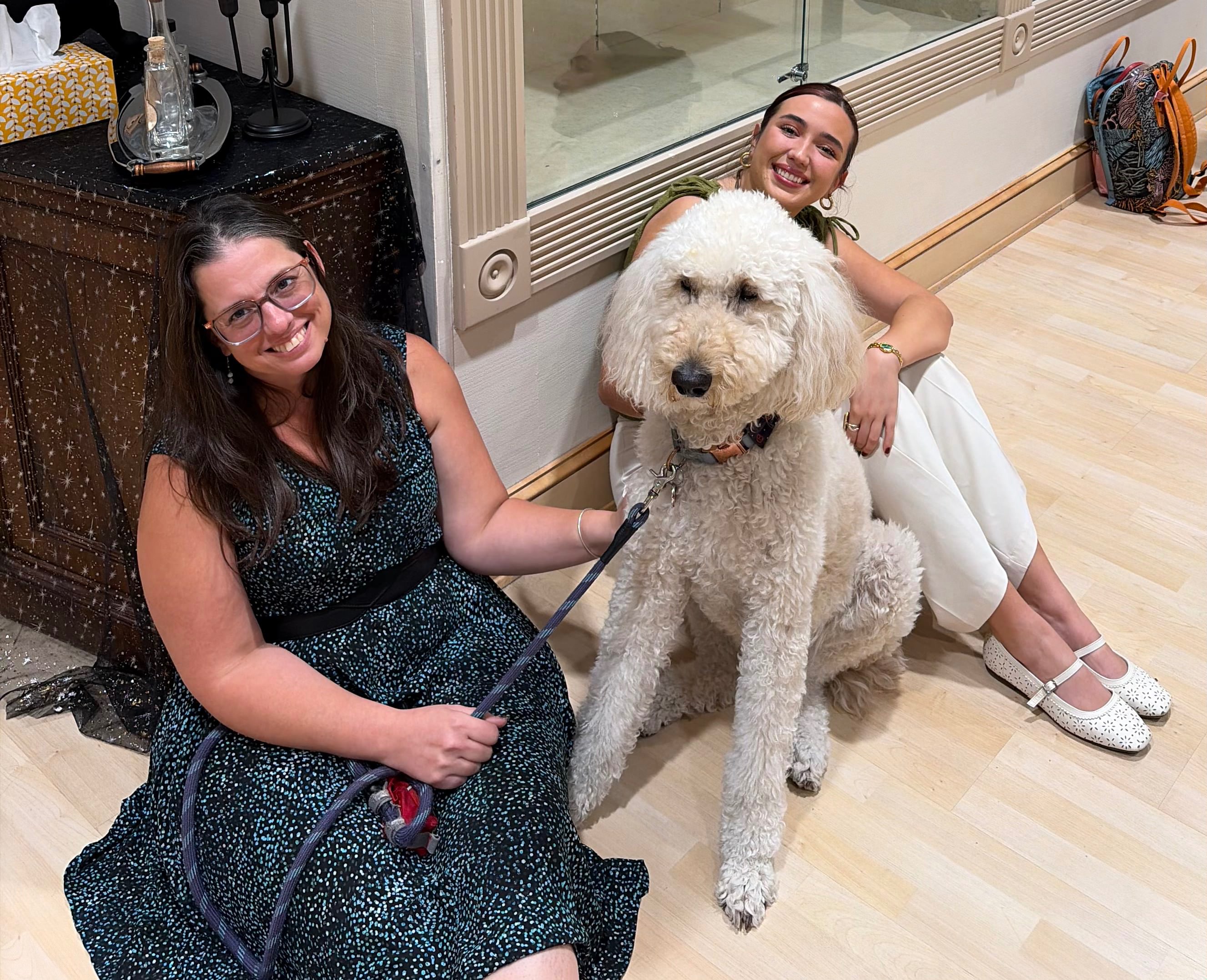 Meagan Zampieri-Lillpopp, left, director of client services for Options poses for a picture with Options therapy dog Arthur "Fonzie" Fonzerelli, middle, and Dianna Angarita, right, FHSU Alumni and co-editor for "Relationship-Based Violence-A Rural Kansas Initiative." Photo by Alin Hett/Hays Post&nbsp;
