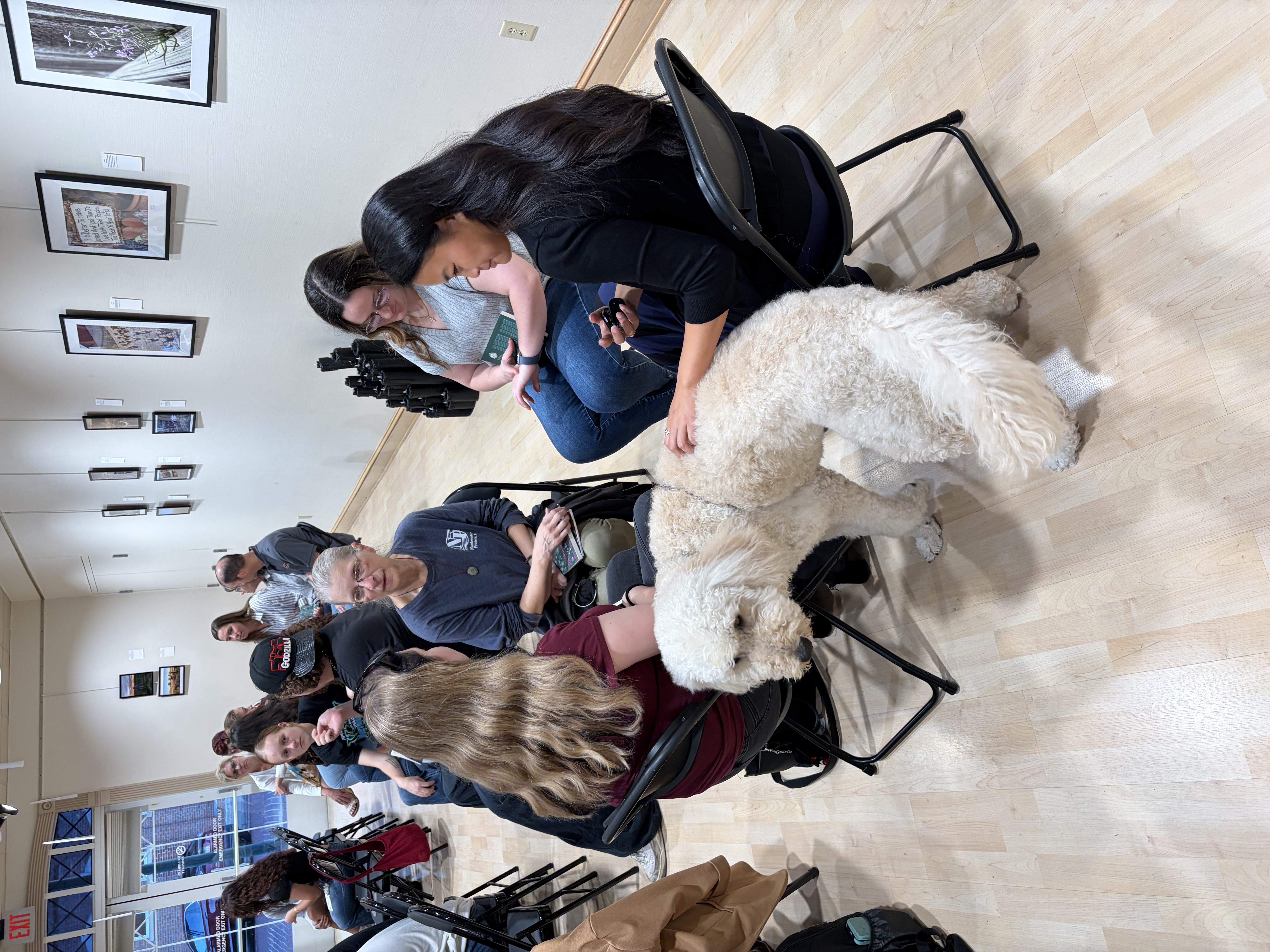 One of the listening circles created by audience members that included Options therapy dog, Fonzie. Photo by Alin Hett/Hays Post.&nbsp;