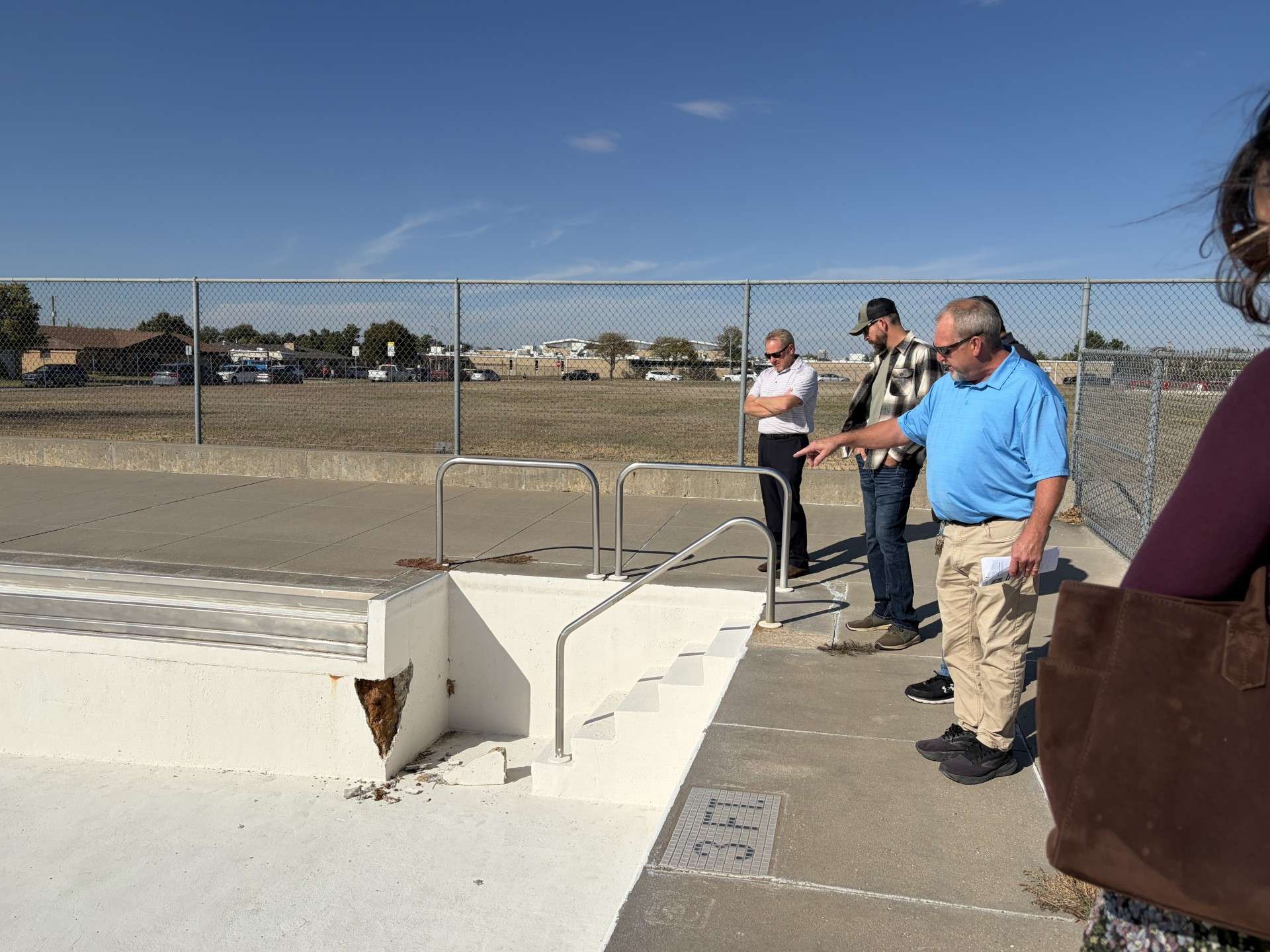 Parks Director Jeff Boyle points to an unexpected wall failure at Wilson Swimming Pool, 28th and Fort, during a tour Thursday of the&nbsp; 54-year-old facility by Hays city commissioners and representatives of the Hays Recreation Commission. Photo by Becky Kiser/Hays Post