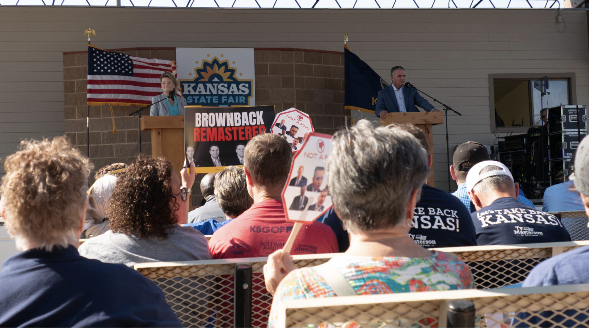 Democrat Cindy Holscher and Republican Ty Masterson appear at the Sept. 12, 2026, debate at the Kansas State Fair. The two rivals for governor agree on the need to reduce property taxes for homeowners but clash on the details. (Photo by Anna Kaminski/Kansas Reflector)
