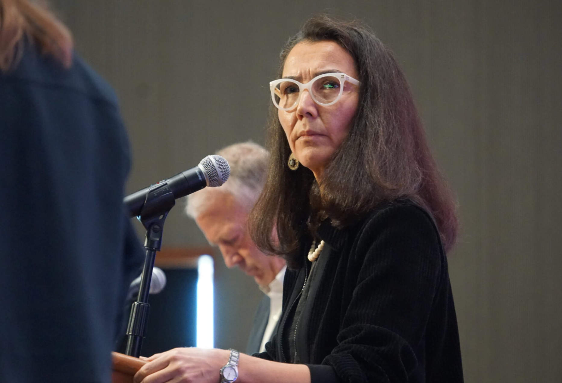 Mary Peltola listens to a question posed by moderator Michelle Egan at a candidate forum held by the Alaska Oii and Gas Association on Aug. 27, 2026. Next to Peltola is Sen. Dan Sullivan. Peltola, a Democrat and former U.S. House member, is challenging Sullivan. (Photo by Yereth Rosen/Alaska Beacon)