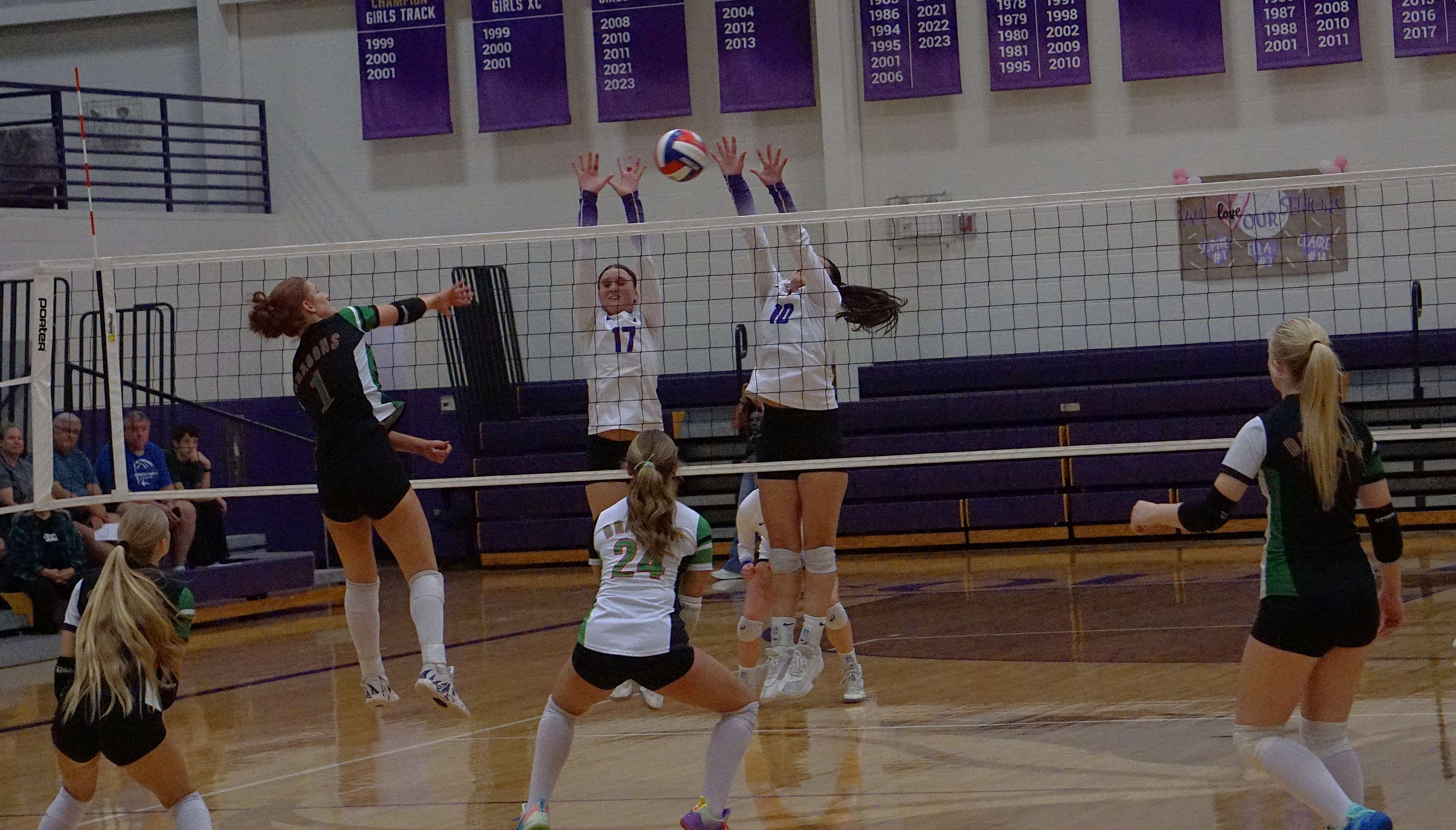 Mid Buchanan's Camryn Atha goes for a kill against the Bishop LeBlond defense of Maya Acosta (10) and Claire Wise (17)/ Photo by Matt Pike