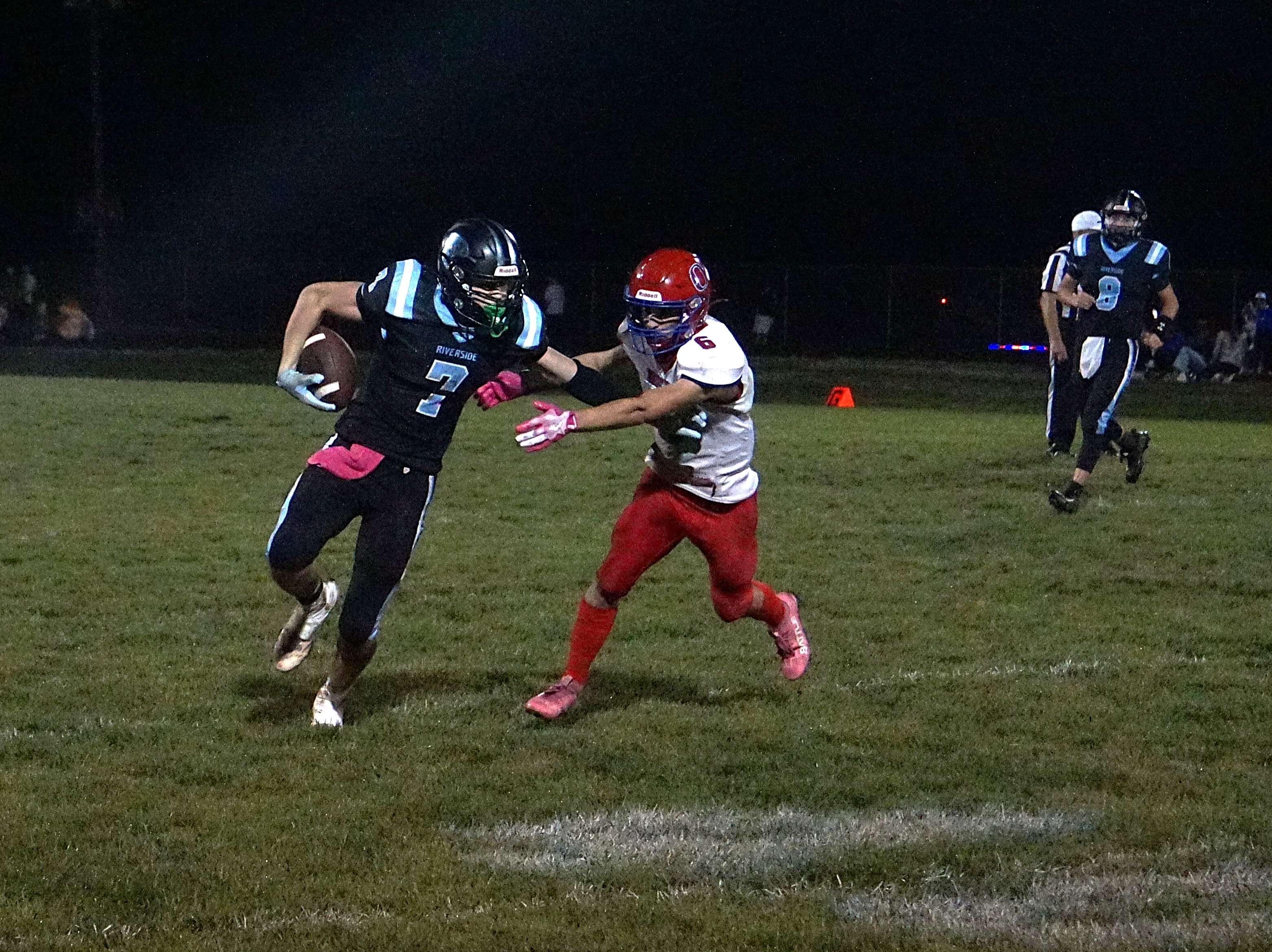 Riverside's Brooks Griffin (7) stiff arms a defender/ Photo by Matt Pike