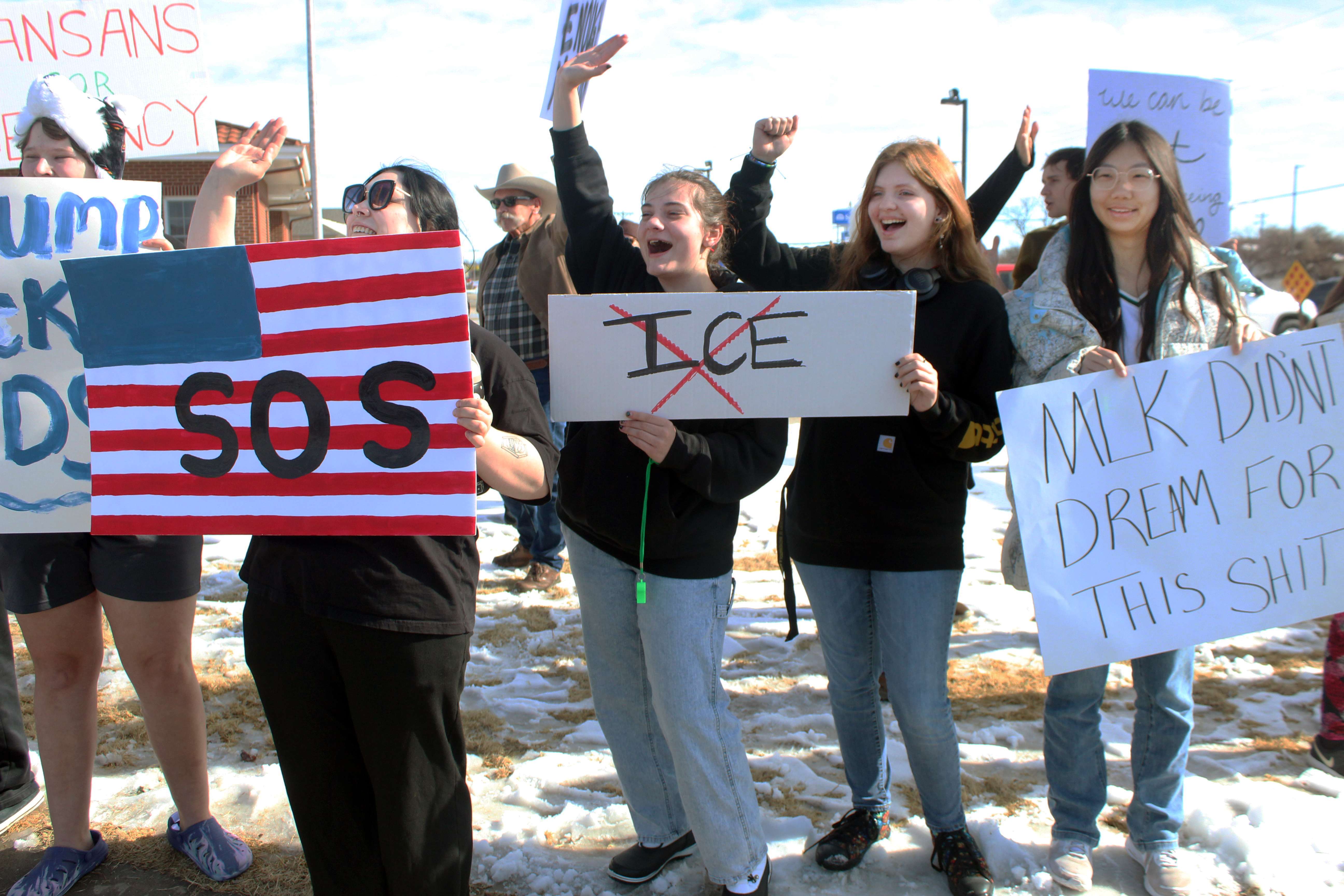 Protesters wave to a supporter who was driving by during a protest at 27th and Vine on Sunday. The protesters were protesting ICE actions in Minneapolis. Photo by Cristina Janney/Hays Post