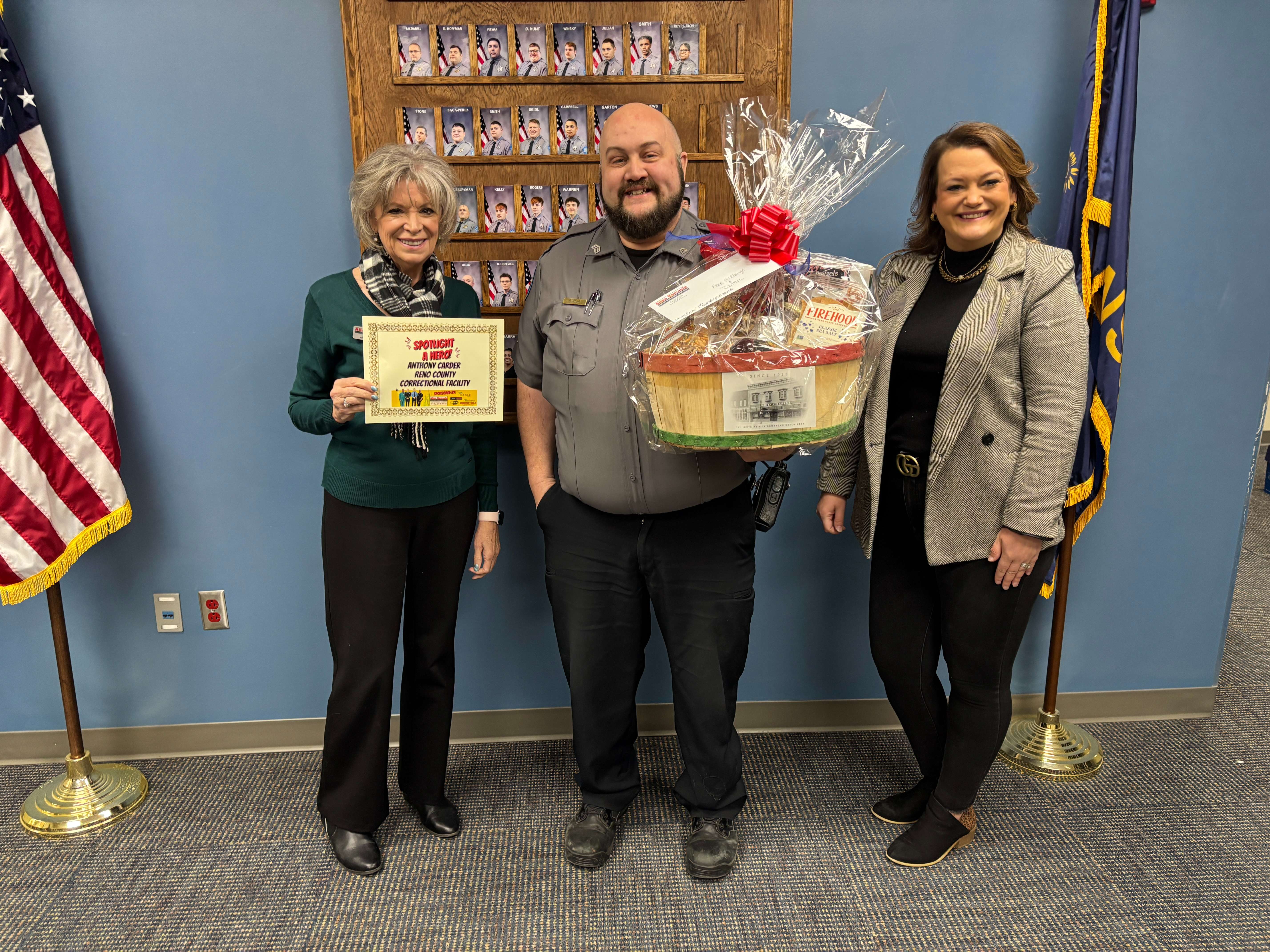 Sgt. Anthony Carder (center) poses with Cris Schul from Allen Samuels Chrysler Dodge Jeep Ram and Ashley Weve from Eagle Media after being named First Responder of the Month for January at the Reno County Correctional Facility in Hutchinson. Carder was nominated by his daughter for his service and community involvement. (Hutch Post Photo)