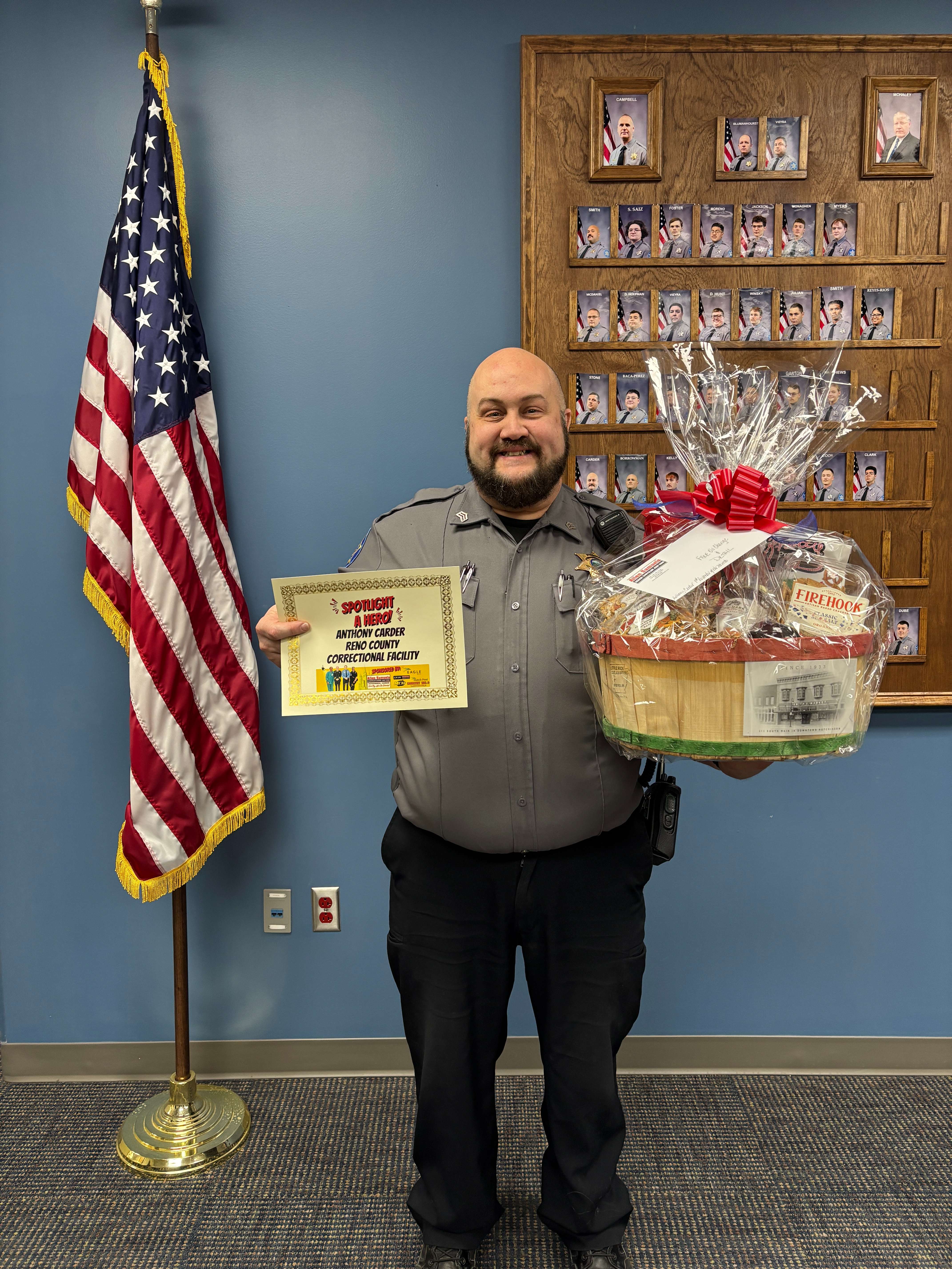 Sgt. Anthony Carder holds his First Responder of the Month certificate and gift basket after being honored in January at the Reno County Correctional Facility in Hutchinson. Carder has served with the Reno County Sheriff’s Office for 17 years. (Hutch Post Photo)