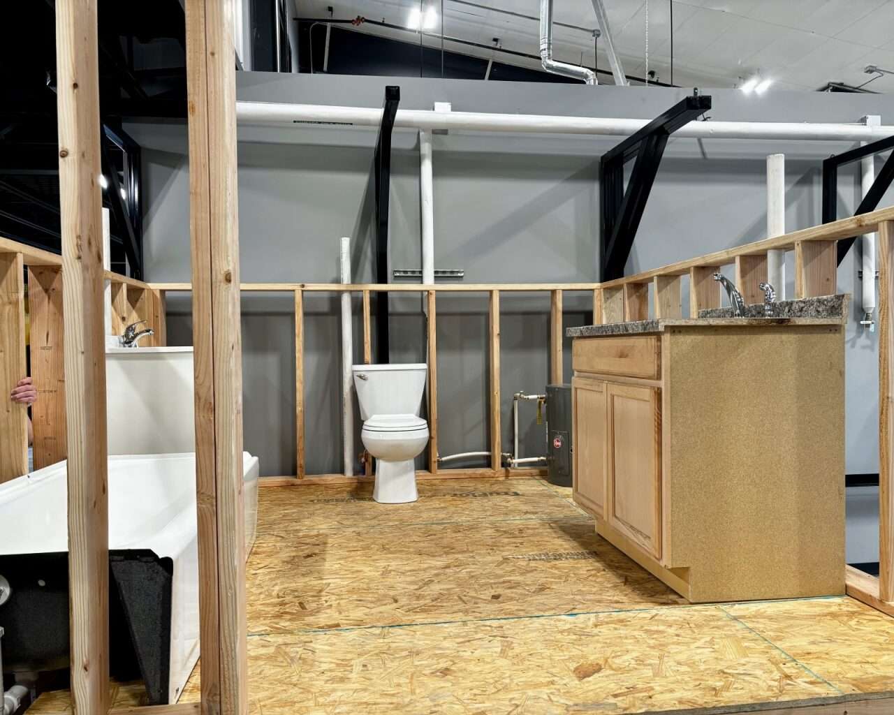 A toilet, sink and bathtub inside the plumbing, heating and air-conditioning lab on the south side of the facility. Photo by Tony Guerrero/Hays Post