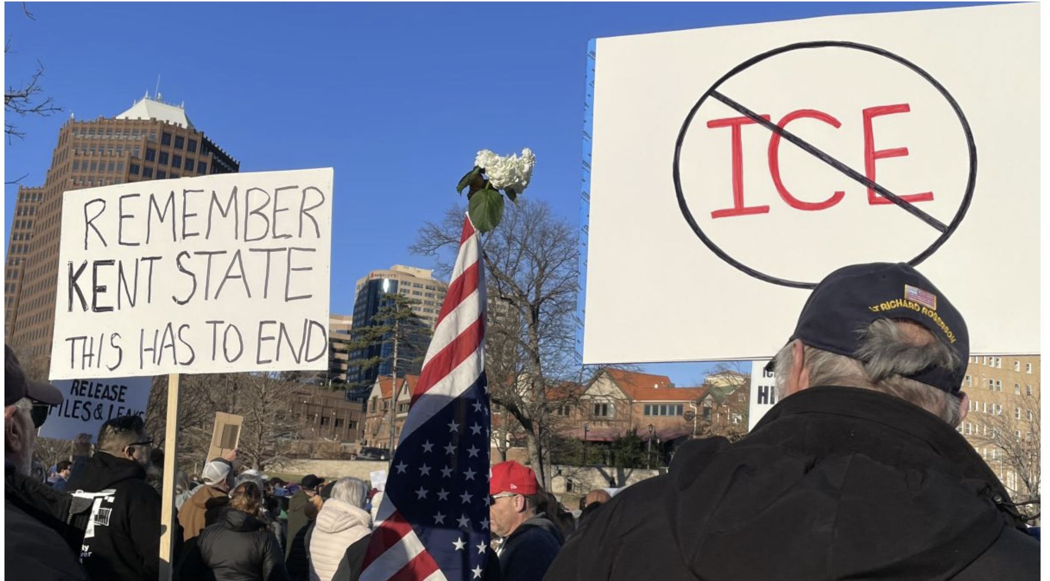  Protesters carrying signs and the American flag at Mill Creek Park near the Country Club Plaza (Mary Sanchez/The Beacon).