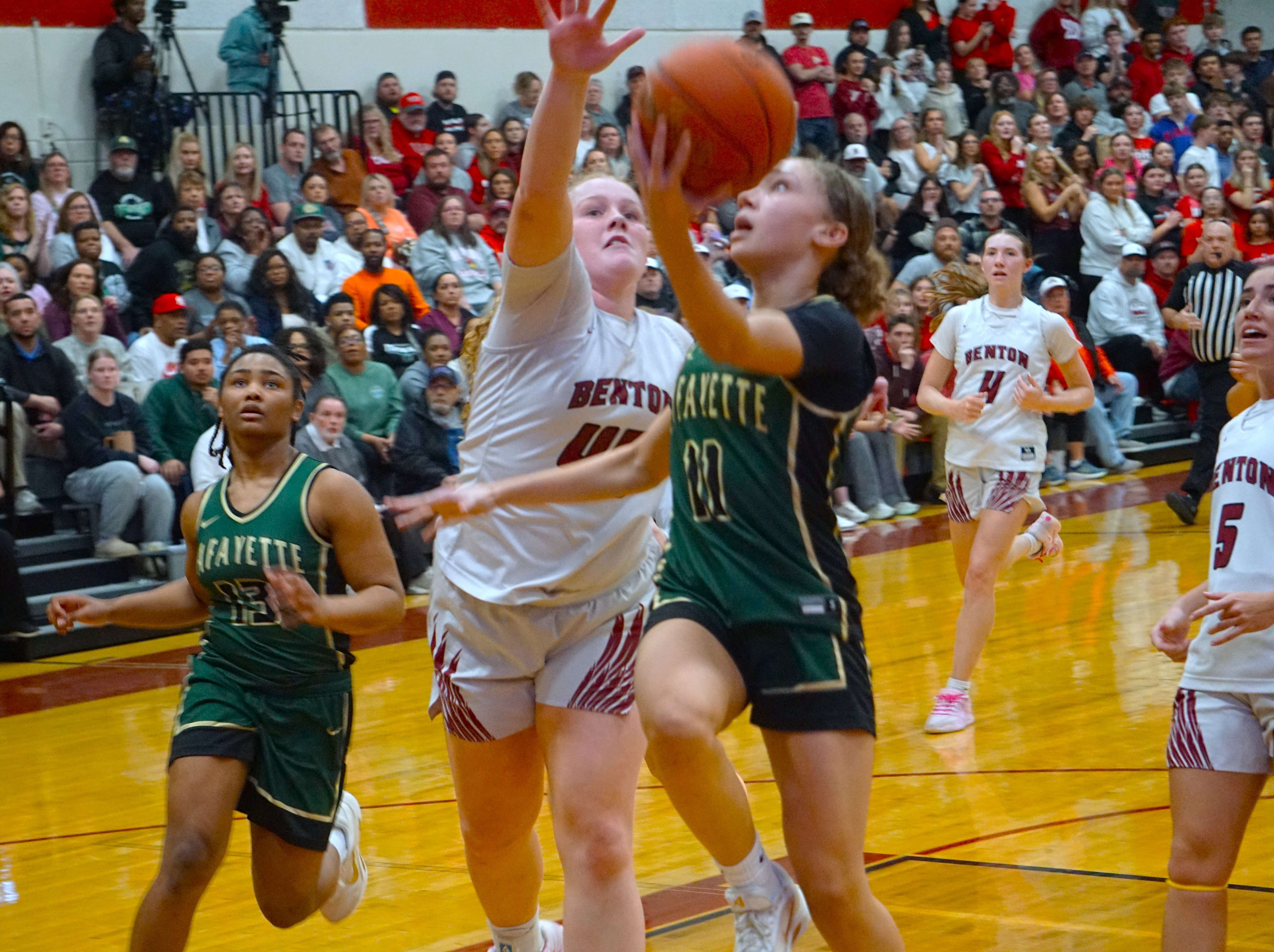 Lafayette's Rozlyn McDevitt (11) goes for the layup as Benton's Klarabelle Turner (45) attempts to block the shot/ Photo by Matt Pike