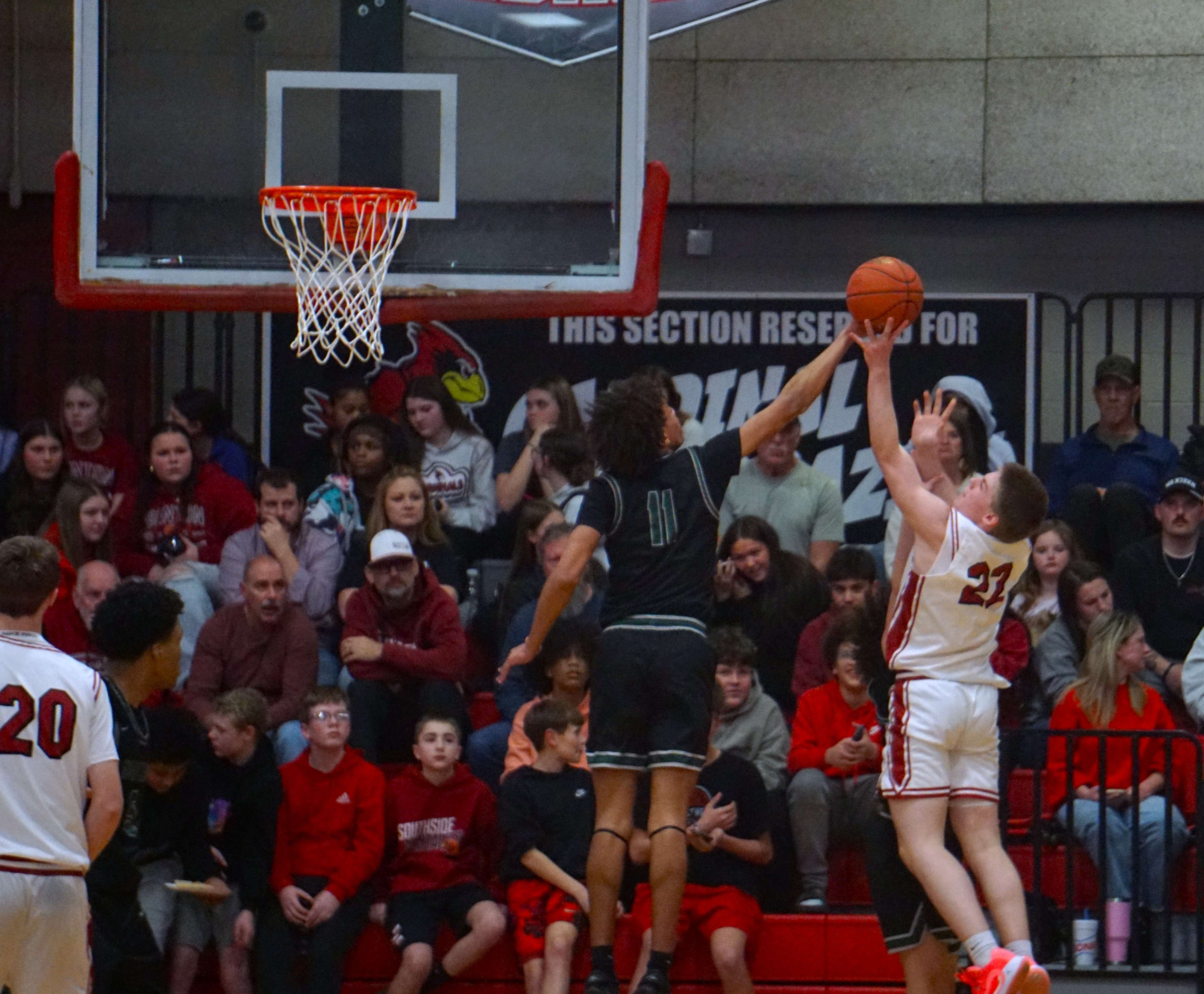 Lafayette's Evan Parksel (11) blocks a shot by Benton's Zaidyn Woodward (22)/ Photo by Matt Pike