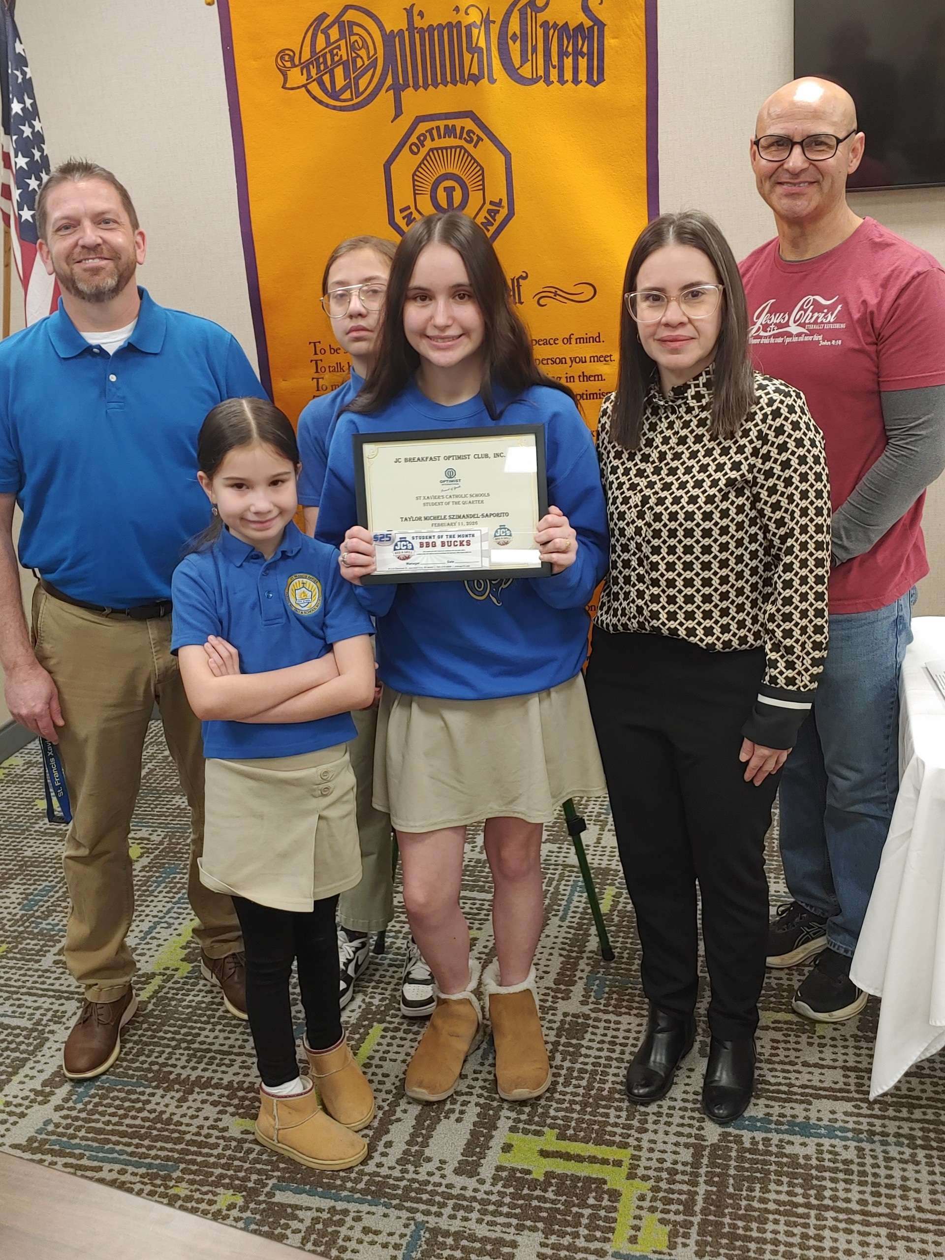 Pictured left to right are Shawn Augustine, St. Xavier's Catholic Schools Principal; Taylor's siblings; Taylor; Erika Gonzales, Taylor's mother and Ricardo Gutierrez, JC Breakfast Optimist Club Junior Optimist Club Facilitator.&nbsp; &nbsp; &nbsp;