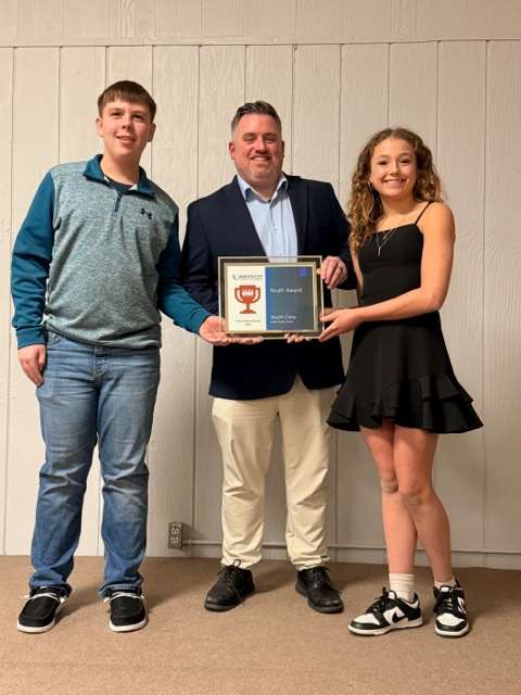 From left: Branson Holinde, Tyler Morton and Mya Brewer accept the Youth Award at the recent Hoisington Chamber of Commerce Banquet.