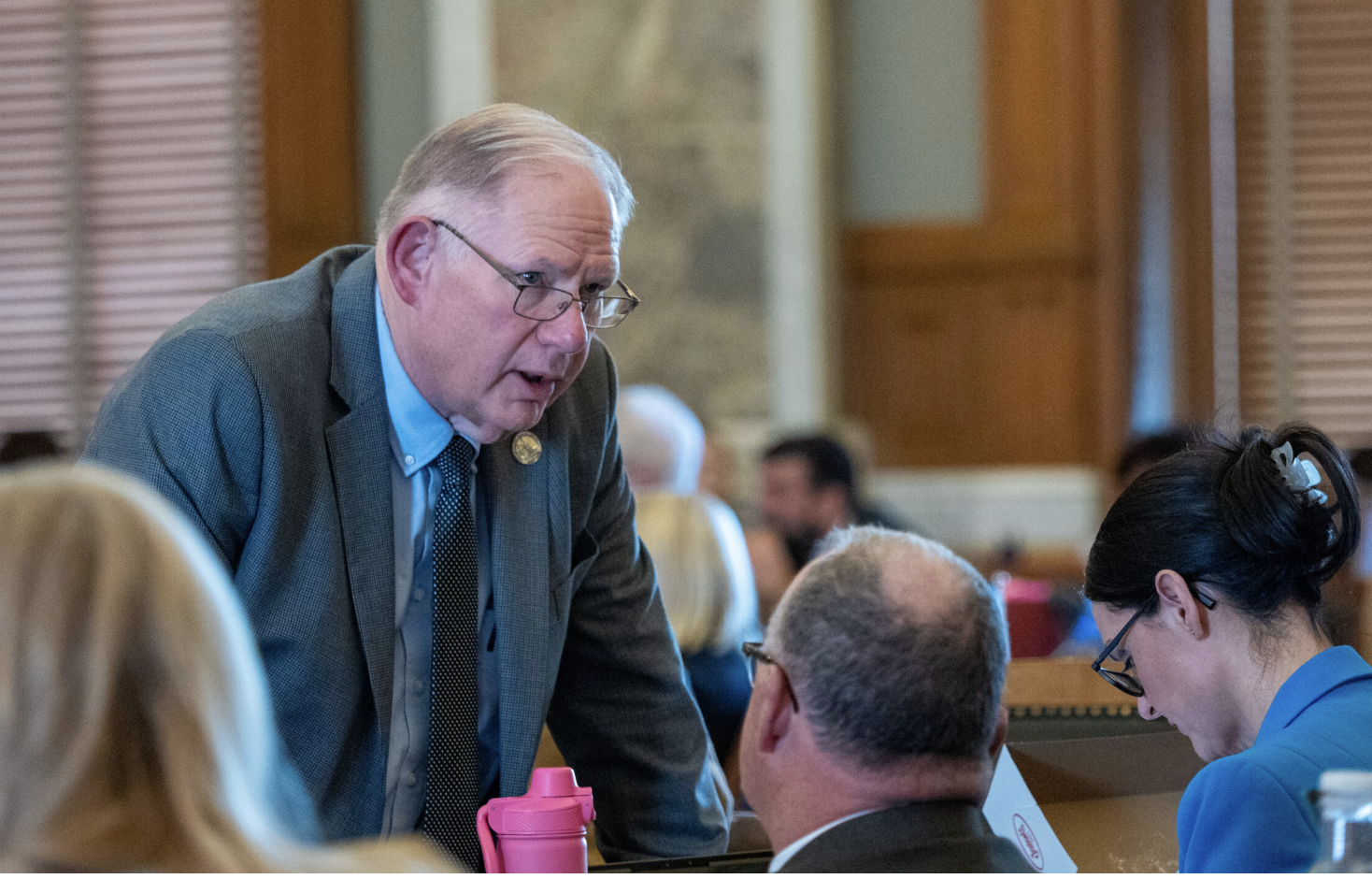House Speaker Dan Hawkins, R-Wichita, talks with colleagues during the Jan. 28, 2026, debate on anti-trans legislation in the House. (Photo by Sherman Smith/Kansas Reflector)