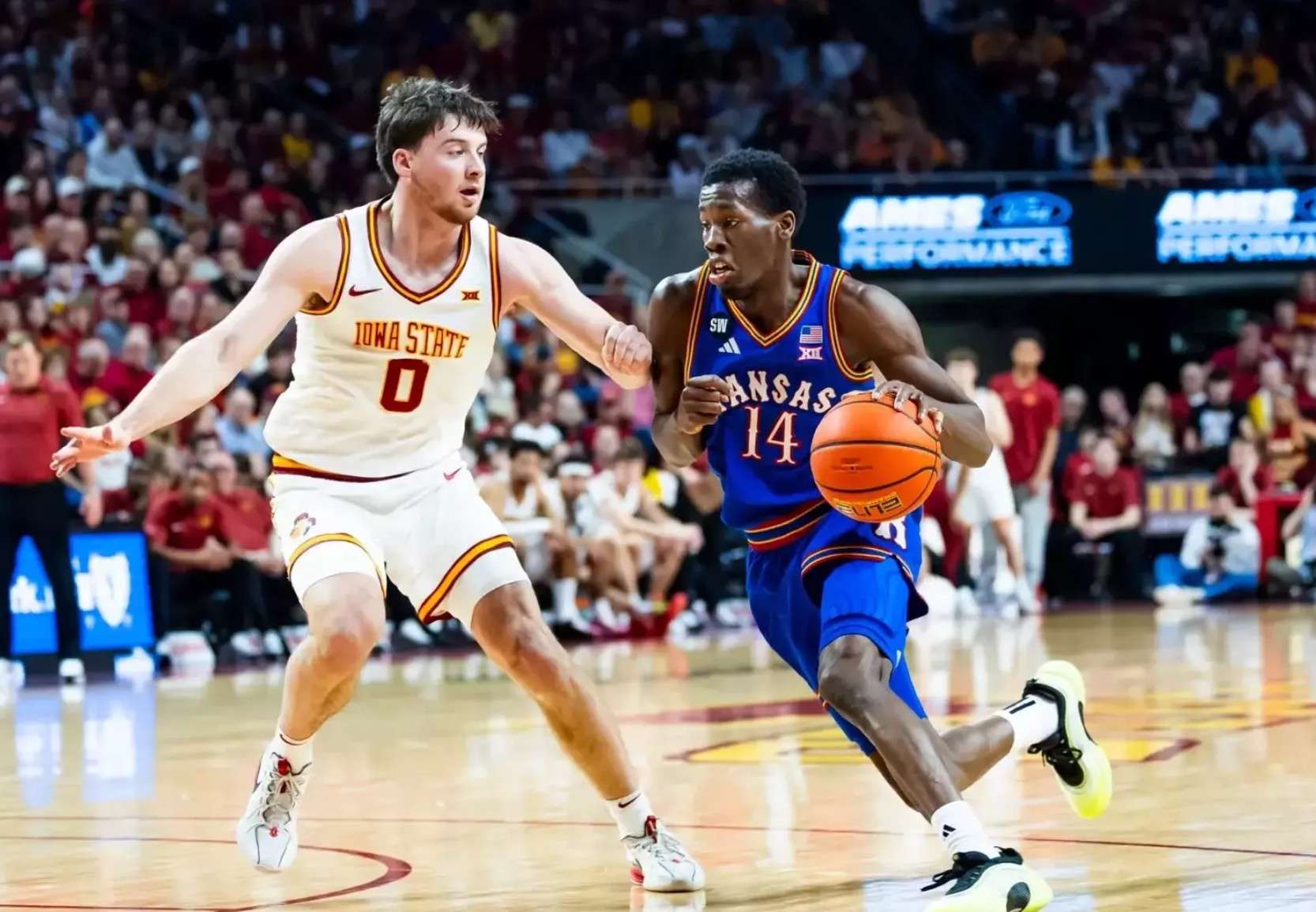 Kansas guard Melvin Council Jr. *14) attempts to get by Iowa State's Nate Heise (0) in the second half of an NCAA college basketball game on Saturday, February 14, 2026 in Ames, Iowa (Kansas Athletics photo)