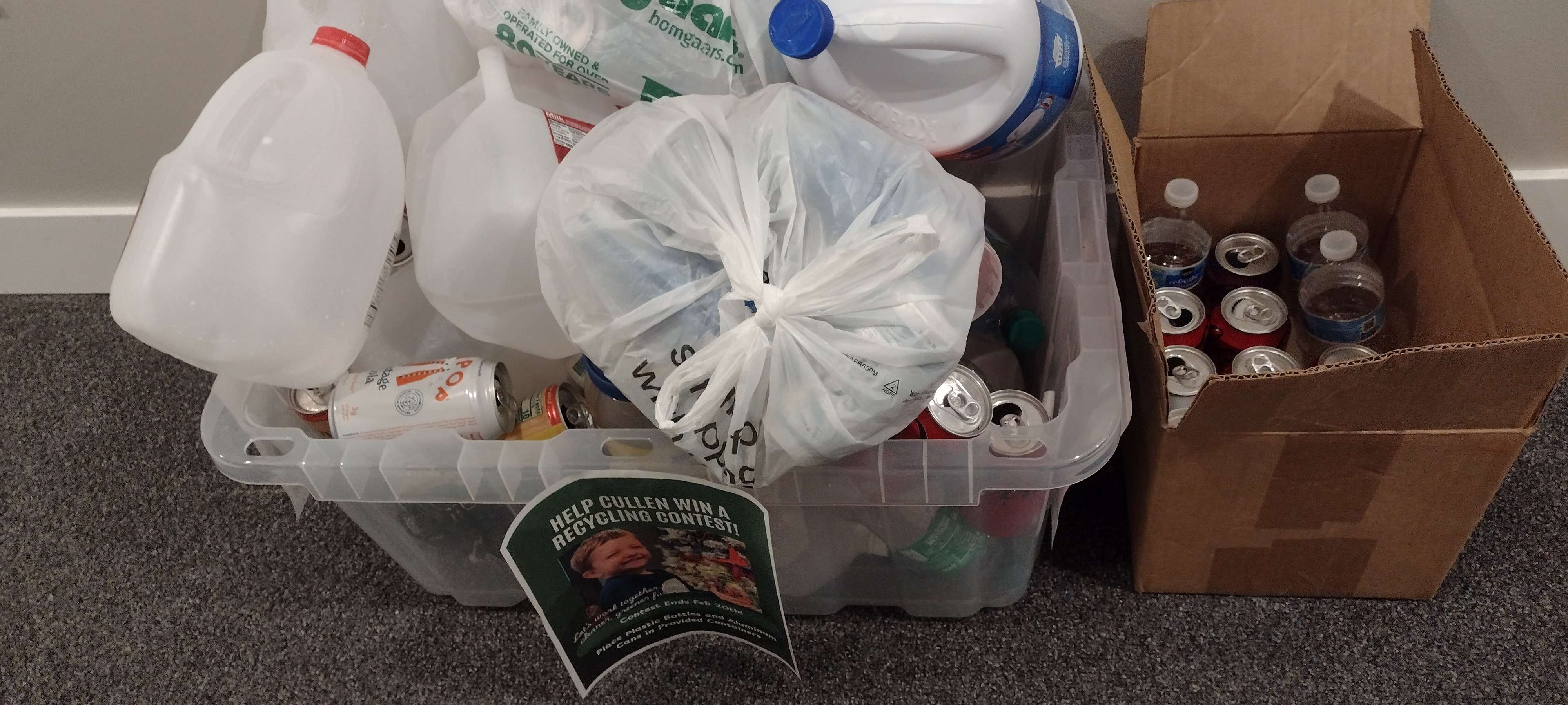 Heartland Flats residents fill fourth-floor containers to help a student win KAB's Pizza Party Recycle Race for his Emerson class.