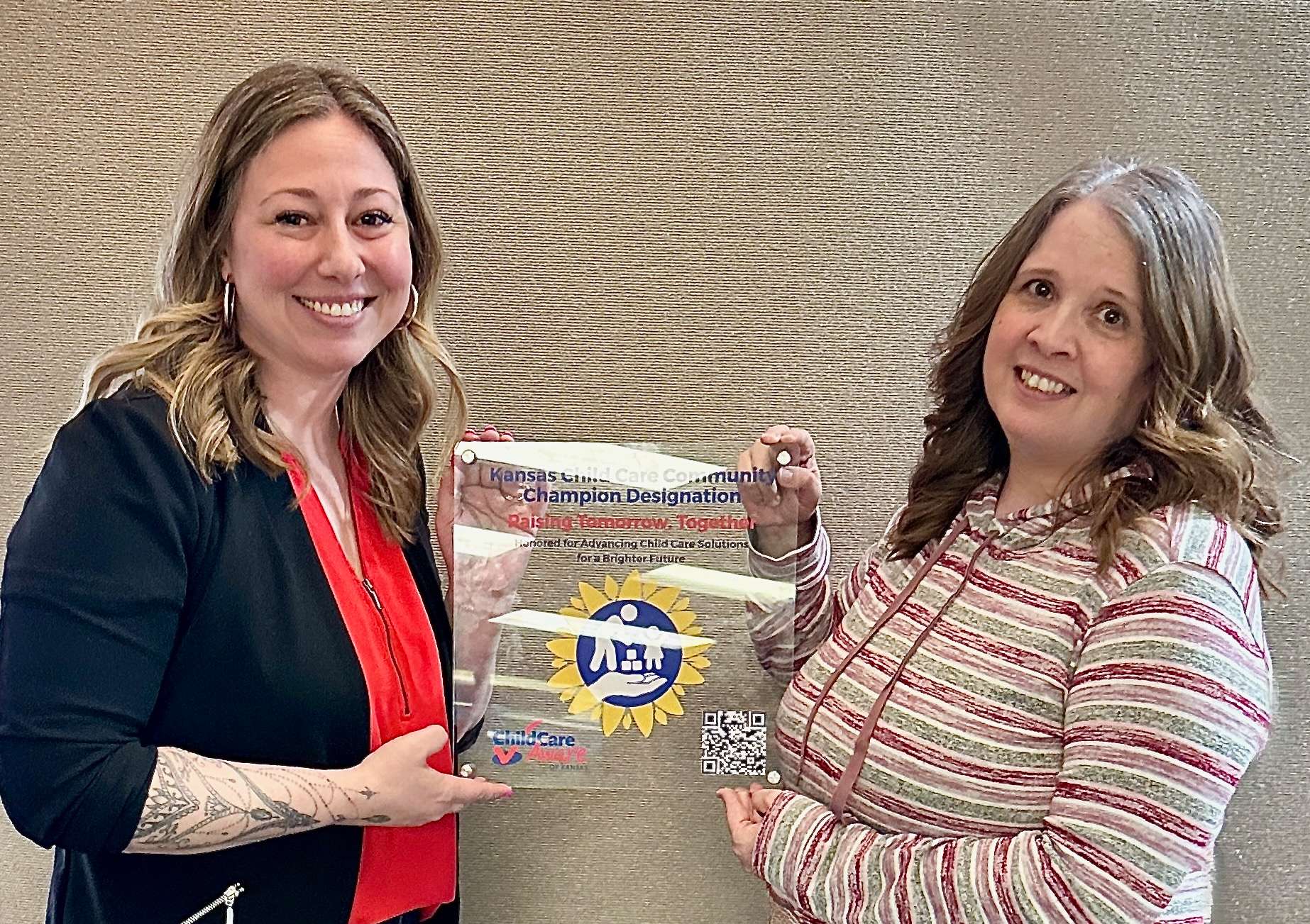 GC3C Program Coordinator Amy Garner (right) is presented with the&nbsp;Child Care Community Champion Award.