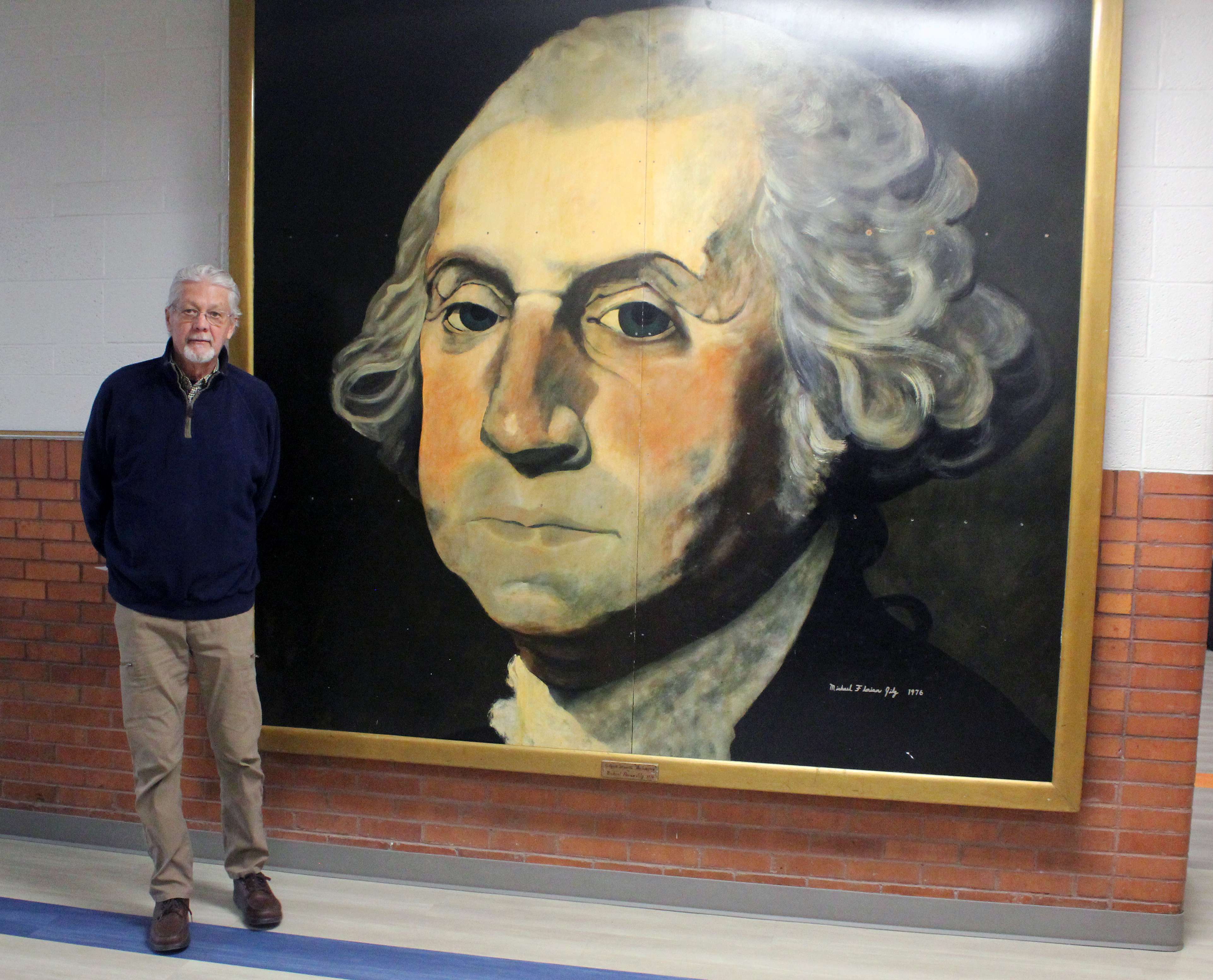 Hayes artist Michael Jilg with a painting of George Washington, which he painted 50 years ago for Washington Grade School in Ellis. Photo by Cristina Janney/Hays Post